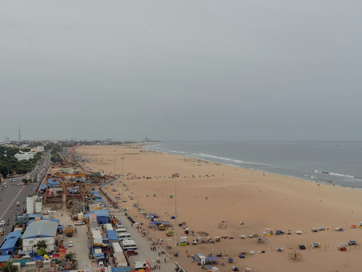 Aerial view of Chennai's Marina Beach curving along the Bay of Bengal beside the city.