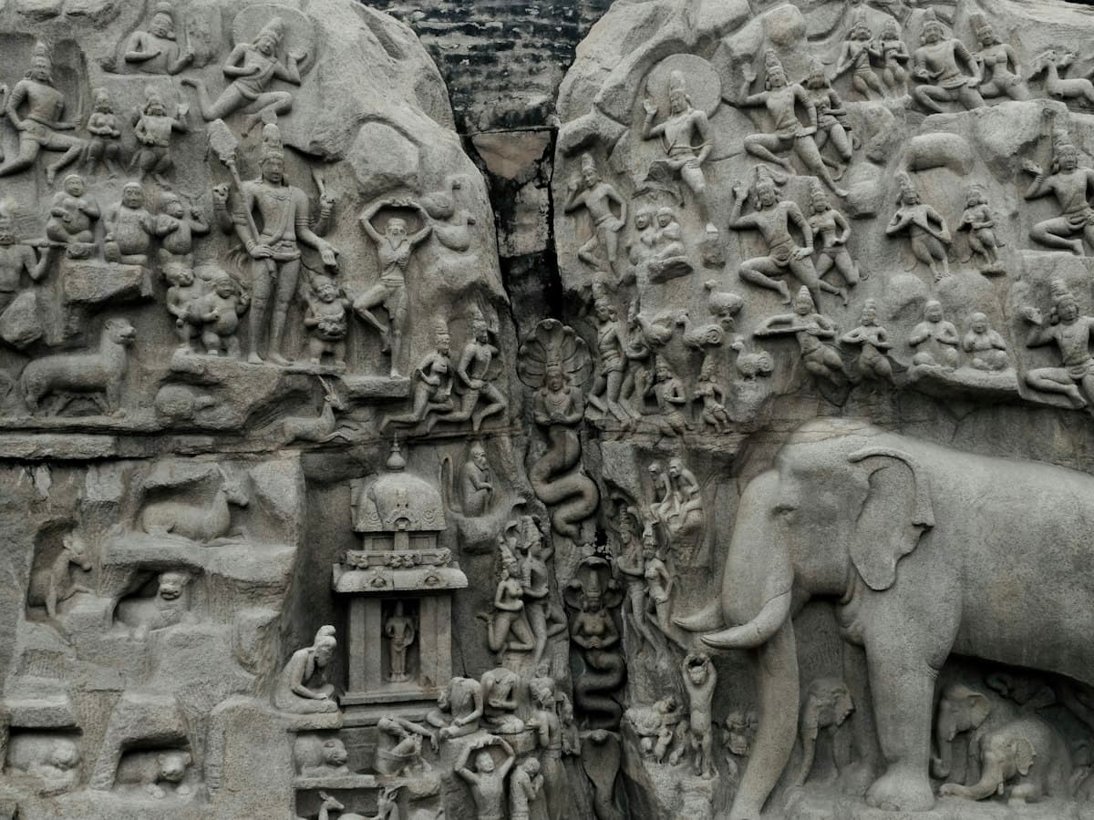 Rock-cut relief carving of elephants and figures by the Pallavas at Mahabalipuram.