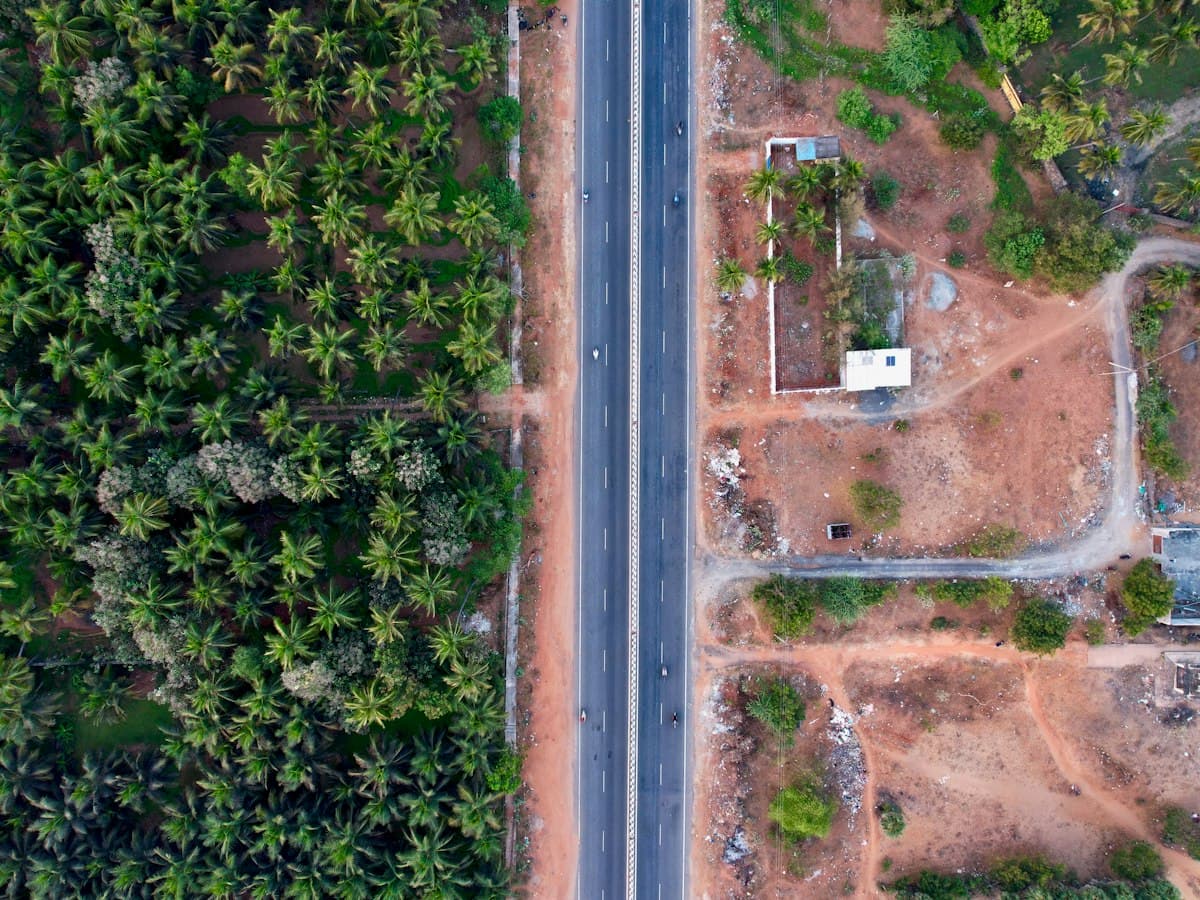 An open coastal highway on the Coromandel coast running toward Puducherry.