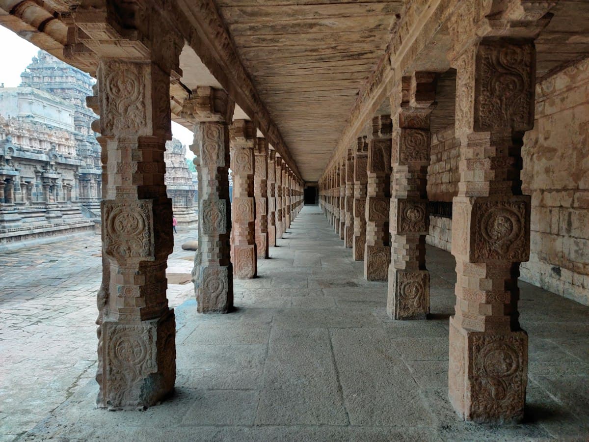 Weathered stone pillars and shrine of a South Indian temple at Kumbakonam.