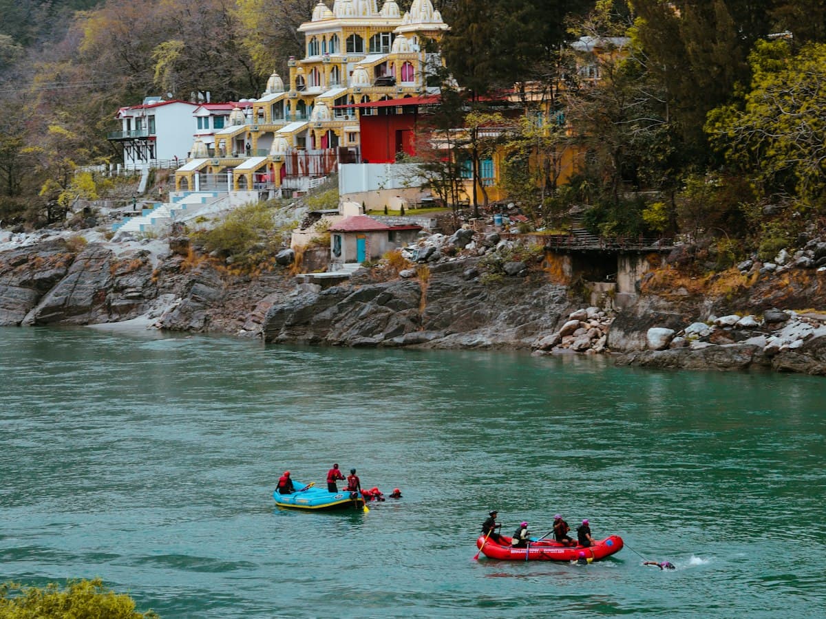 Rafters paddle a canoe-style raft through white water on the Ganges near Rishikesh.