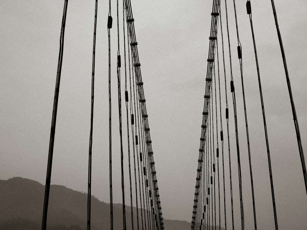 A guided group crosses a riverside bridge near an ashram in Rishikesh, Uttarakhand