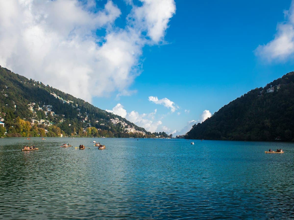 Rowing boats on Naini Lake at Tallital, Nainital, ringed by wooded hills