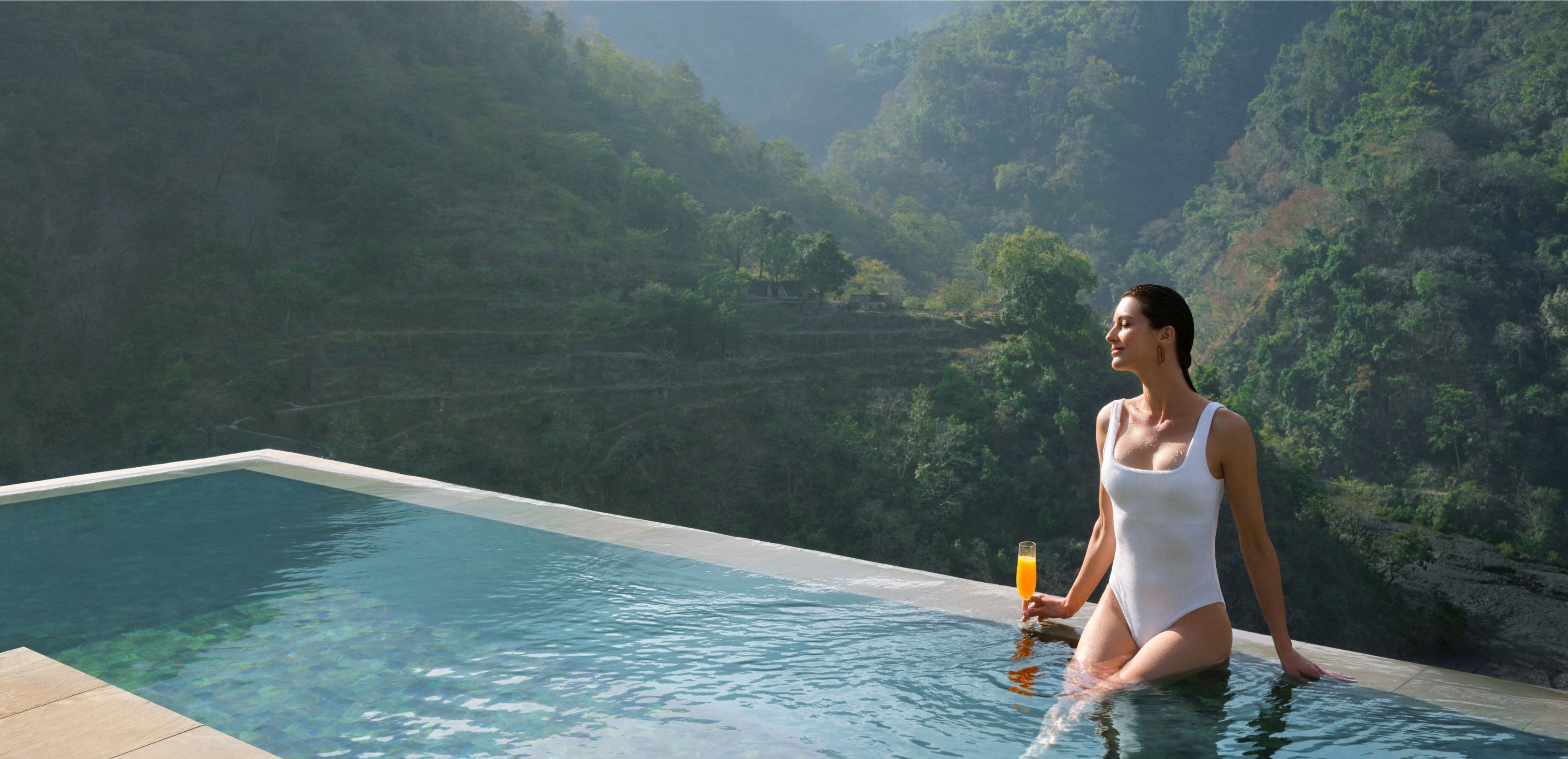 Infinity pool overlooking the forested Ganges valley at Taj Rishikesh Resort & Spa.