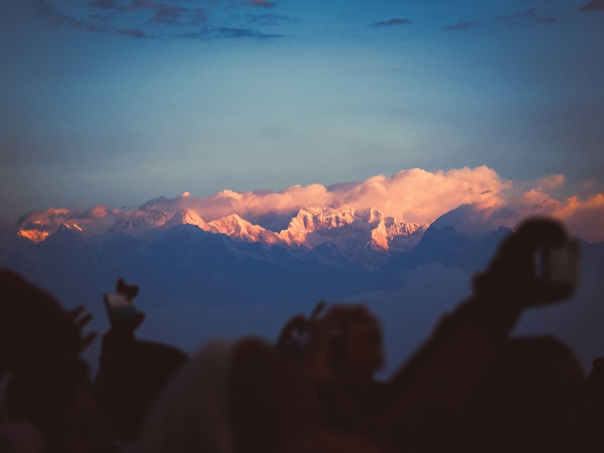 Visitors photographing the view at the Tiger Hill sunrise viewpoint near Darjeeling