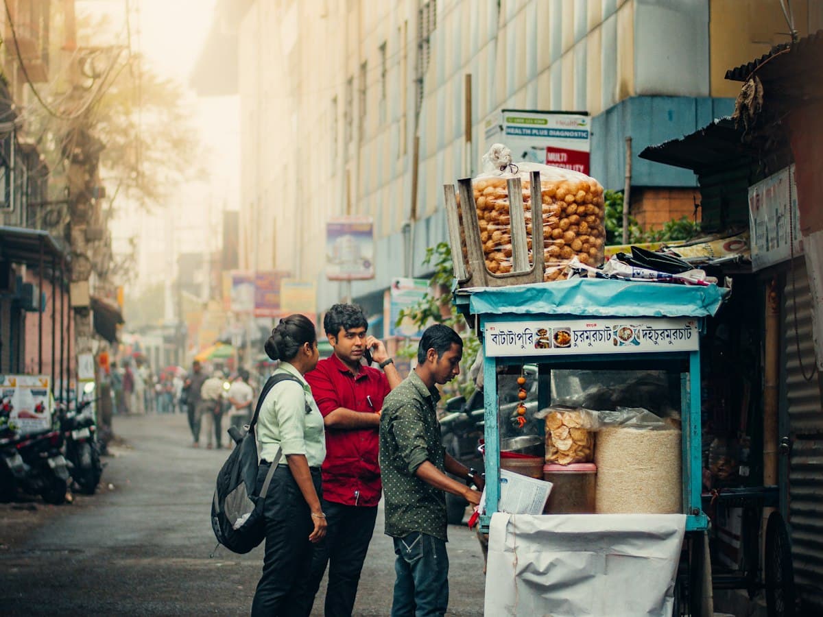 People buying golgappa (puchka) from a street food cart at Garia Bazaar, Kolkata