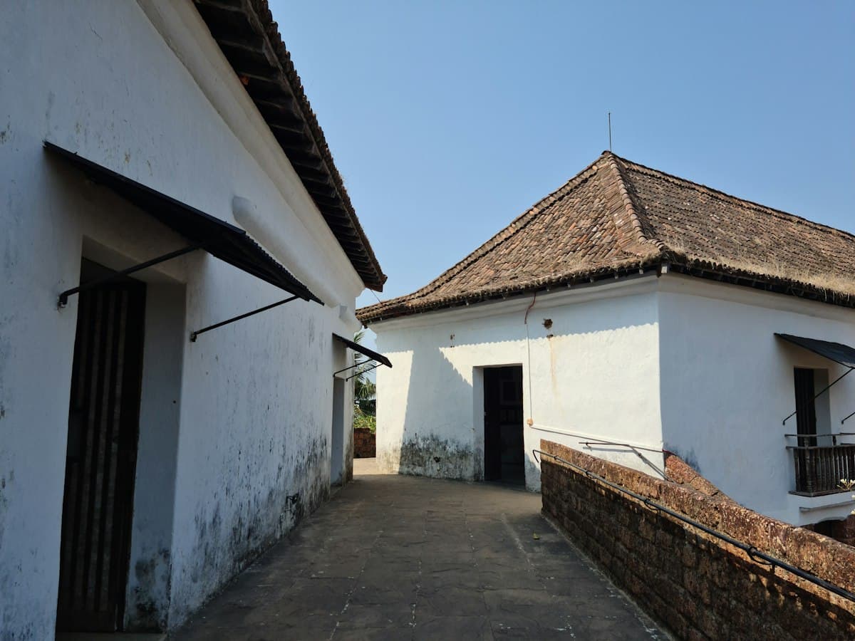 Whitewashed Portuguese-era ramparts and tiled roofs at Reis Magos Fort