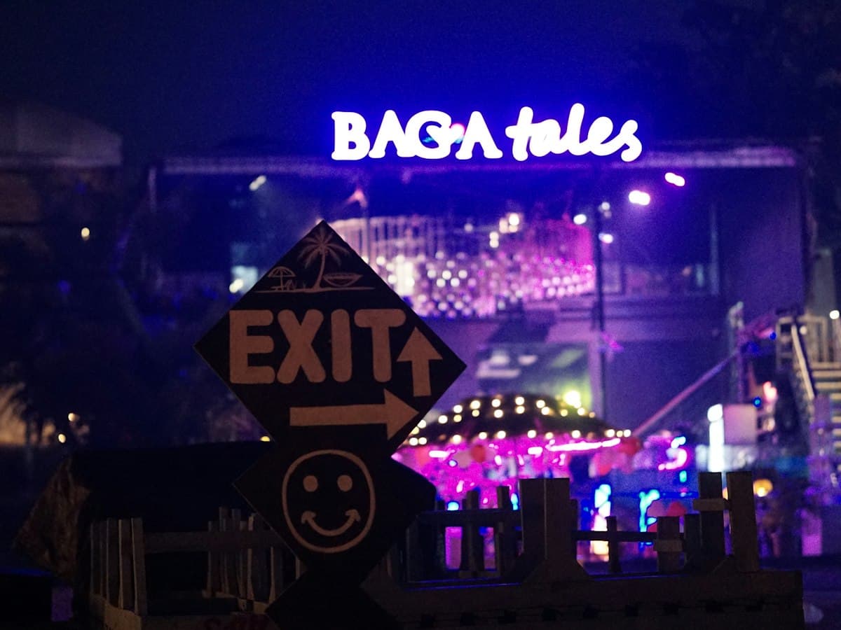 Neon-lit Baga Tales venue at night on Baga Beach, Goa