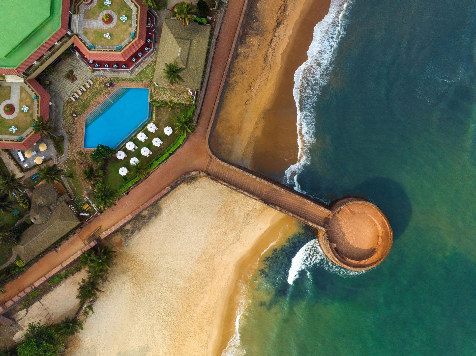 Overhead view of the resort pool, beach and Fort Aguada jetty at Taj Fort Aguada