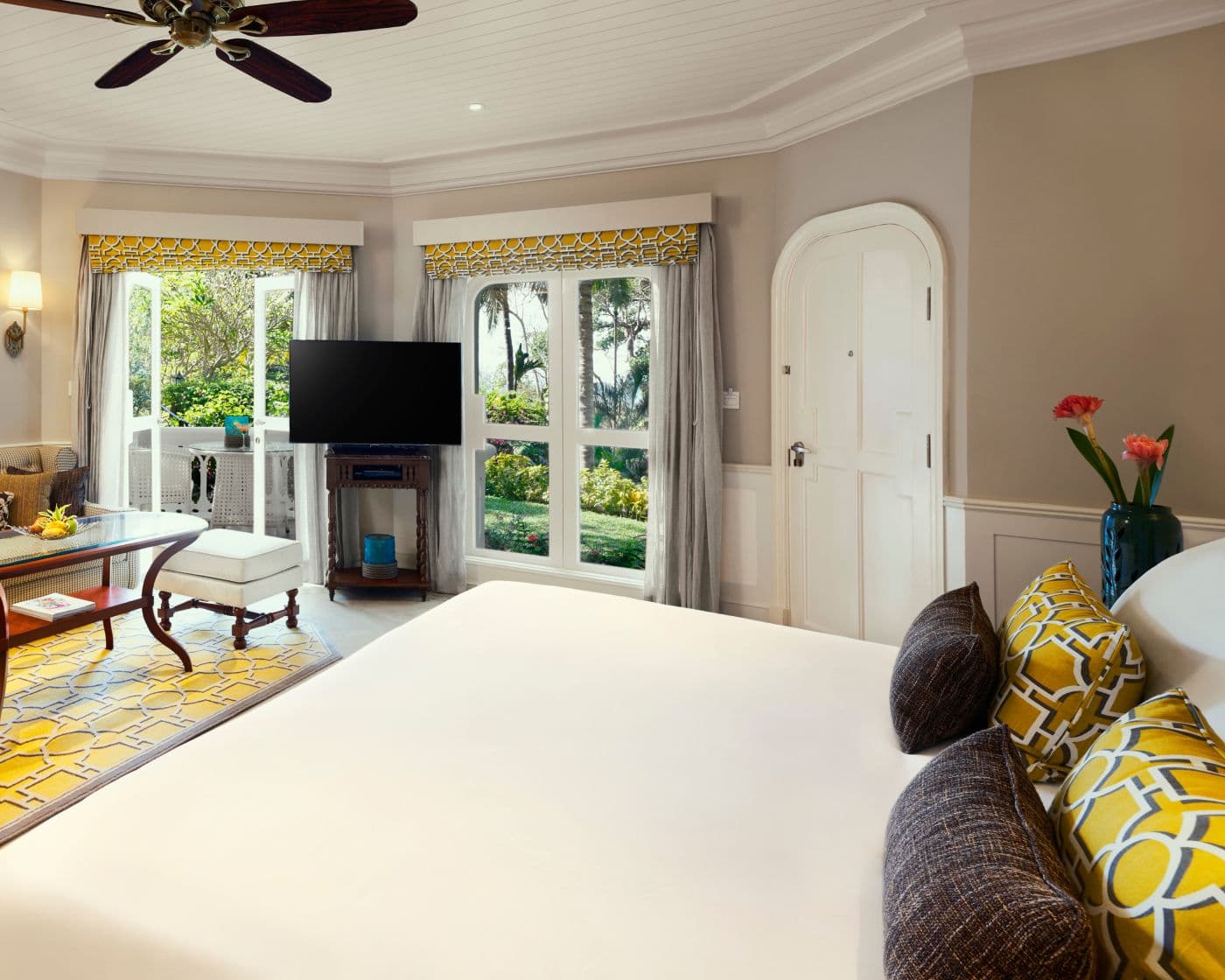 Aguada Cottage Garden View with double bed and yellow accents at Taj Fort Aguada Resort & Spa