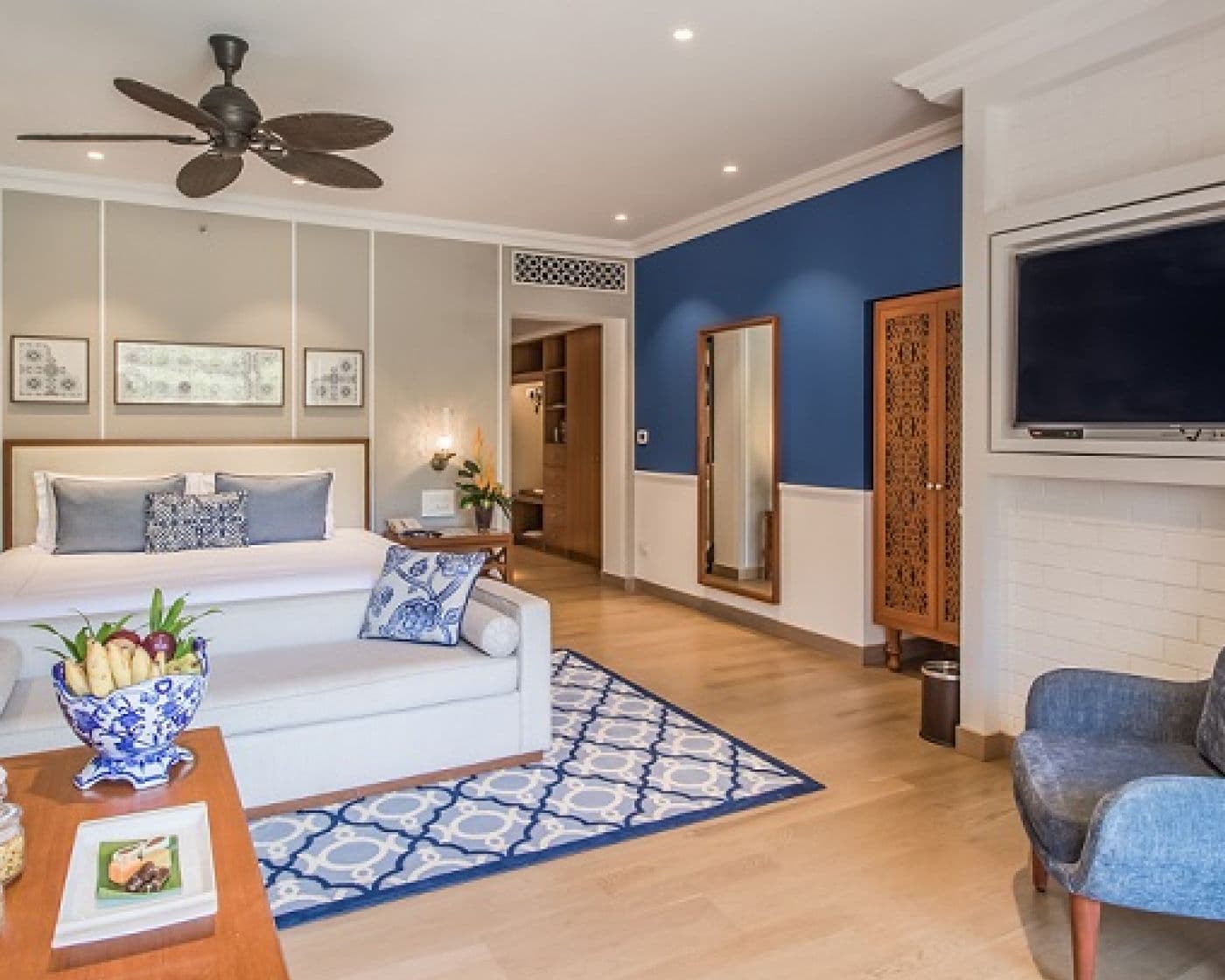Premium Villa Room with king bed and blue-and-white interiors at Taj Exotica Resort & Spa