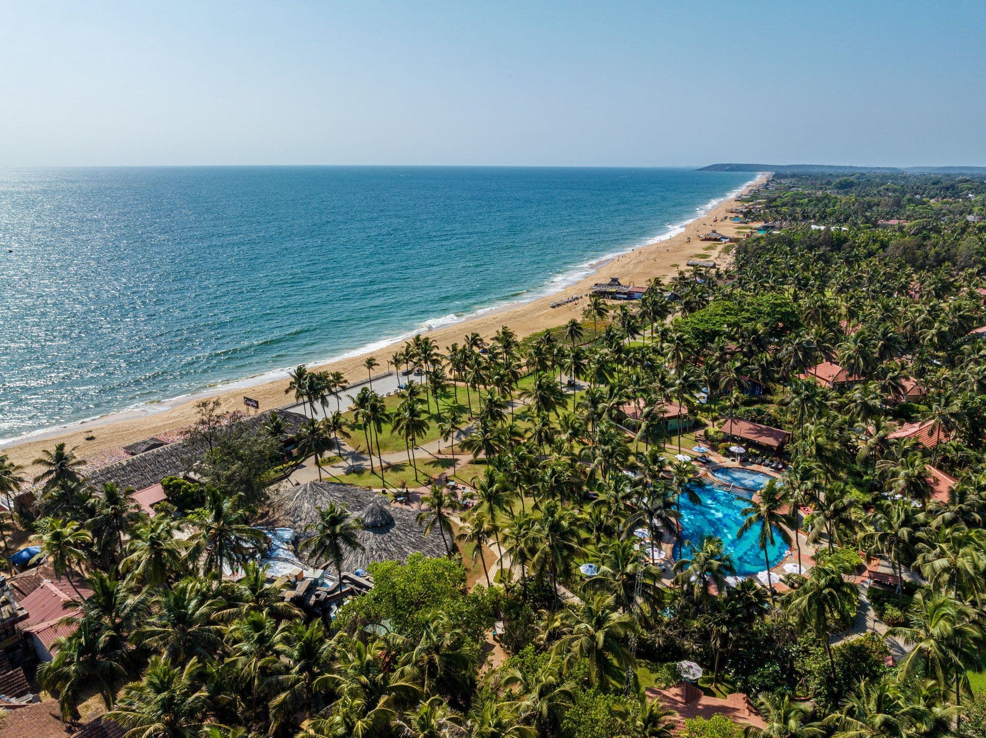 Aerial view of the beach and palm-fringed grounds of Taj Holiday Village Resort & Spa, Sinquerim