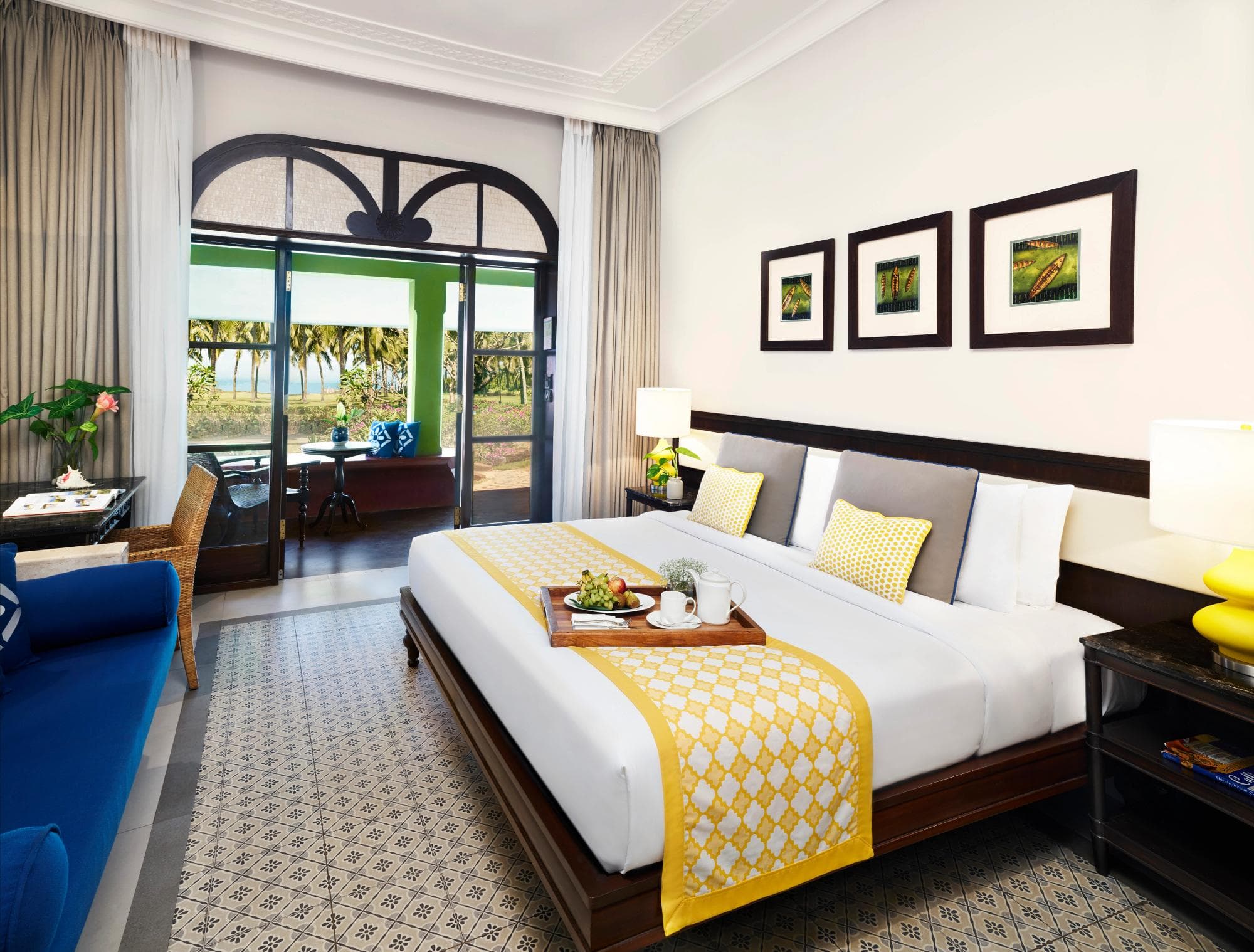 Bedroom with king bed and balcony doors at Taj Holiday Village Resort & Spa, Goa