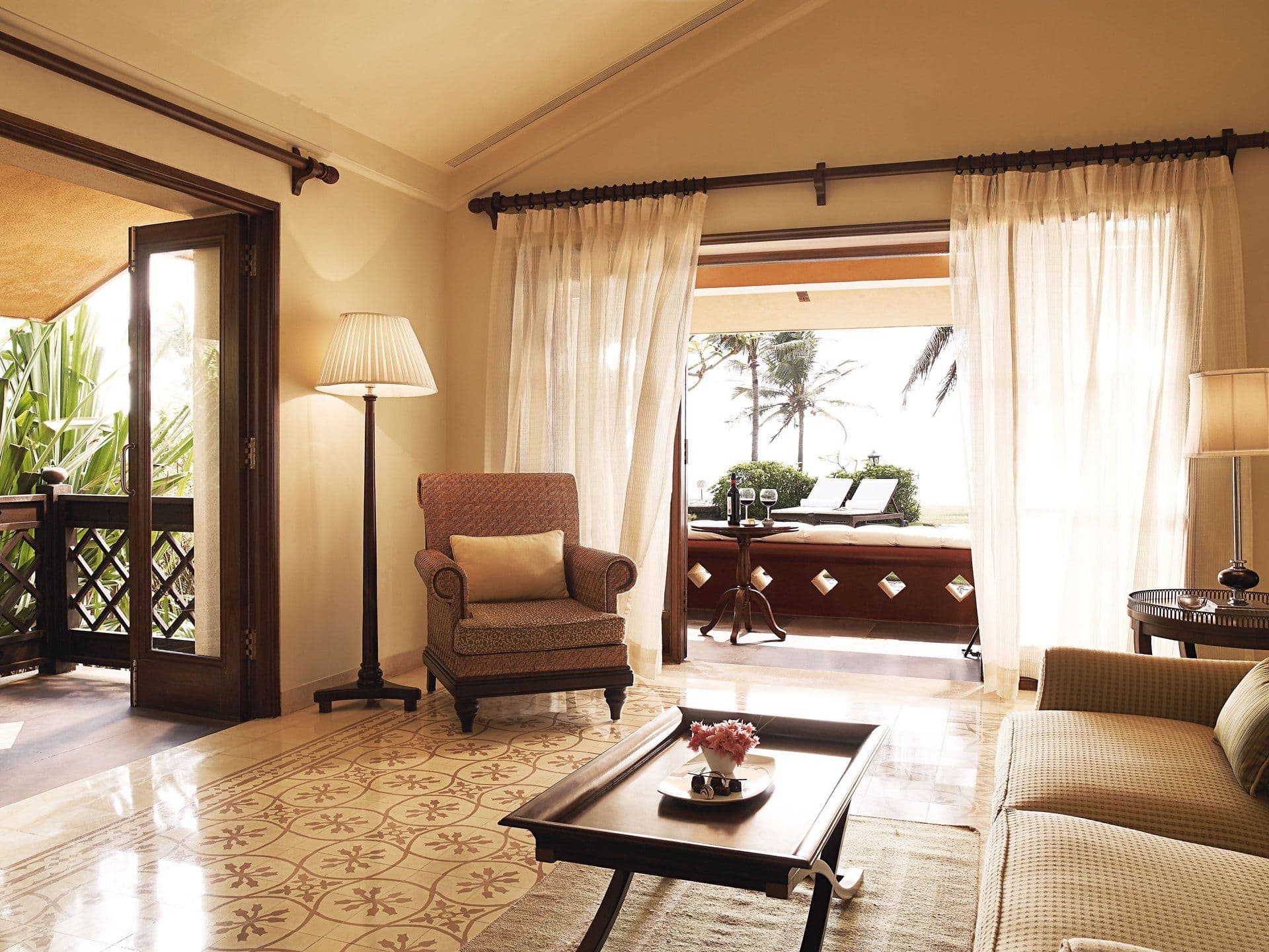 Villa room with sitting area and sea-facing veranda at Taj Holiday Village Resort & Spa