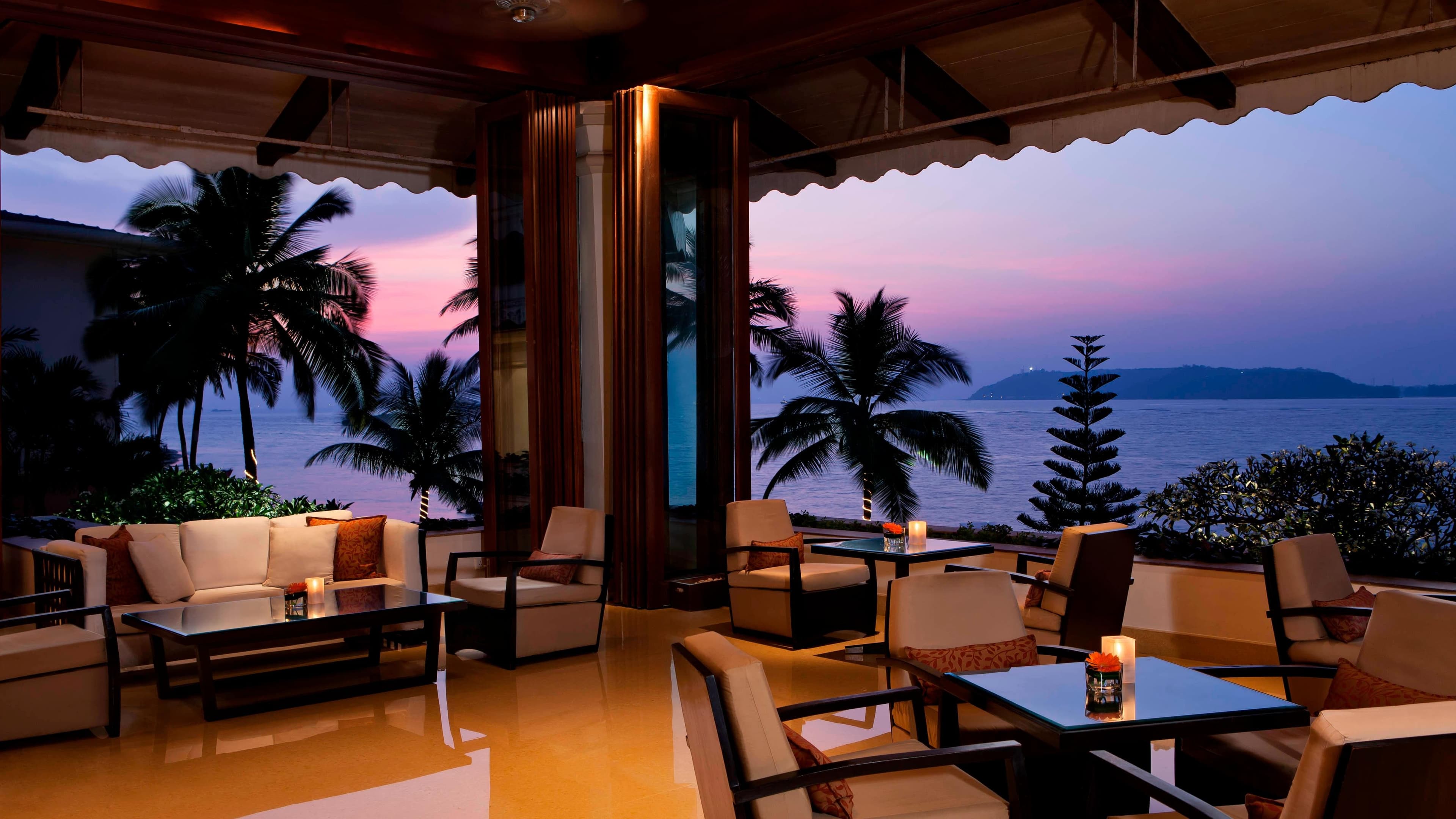 Waterfront lounge terrace at dusk overlooking the sea at Goa Marriott Resort & Spa