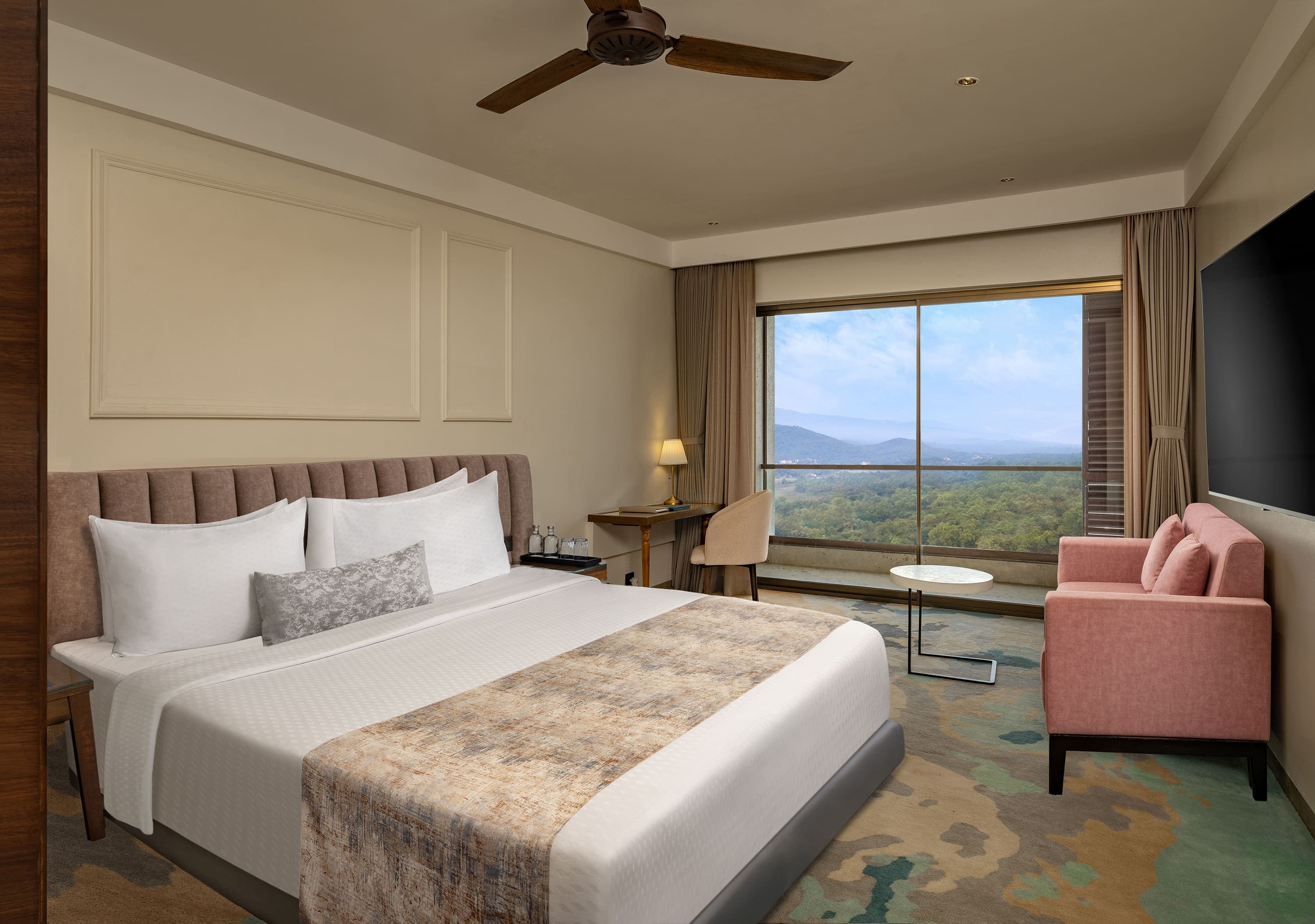 Room with king bed and floor-to-ceiling window over the hills at Gateway Goa, Palolem