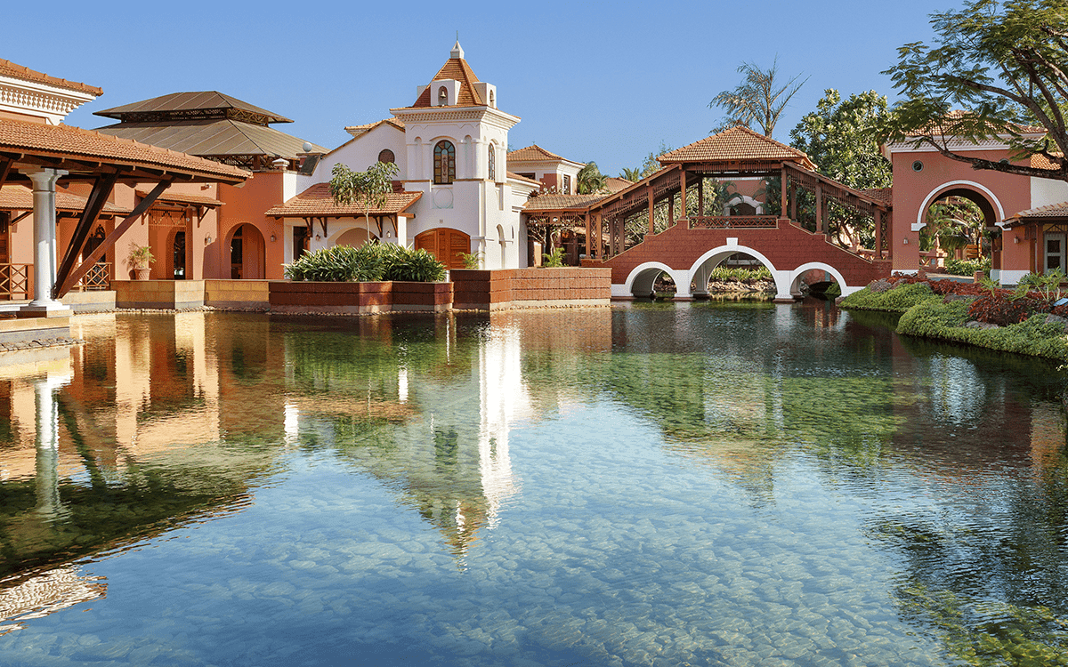 Portuguese-style chapel-inspired facade reflected in the lagoon at ITC Grand Goa