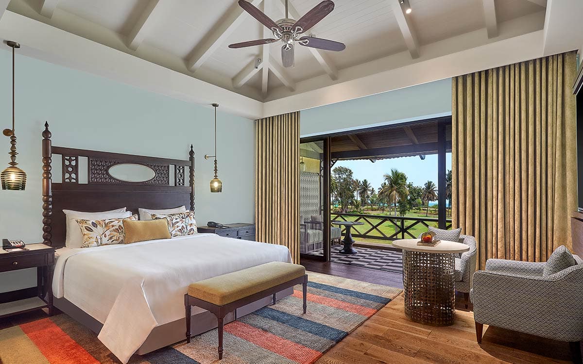 Sea View Room with king bed and balcony over the resort grounds at ITC Grand Goa