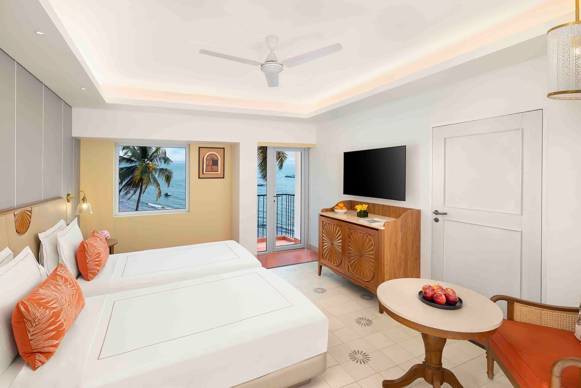 Room with twin beds and window over the palms and sea at Taj Cidade de Goa Heritage