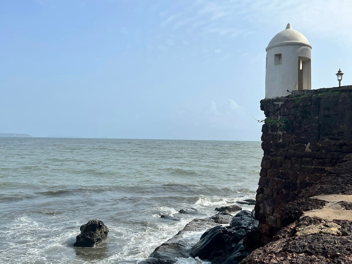 Lighthouse on the cliff edge at Fort Aguada above the sea, Candolim, Goa