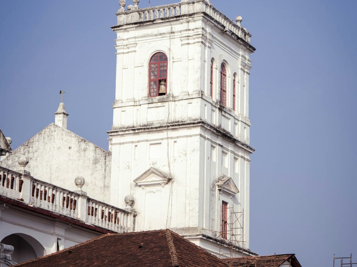 Whitewashed church facade with clock tower in Old Goa (Velha Goa)