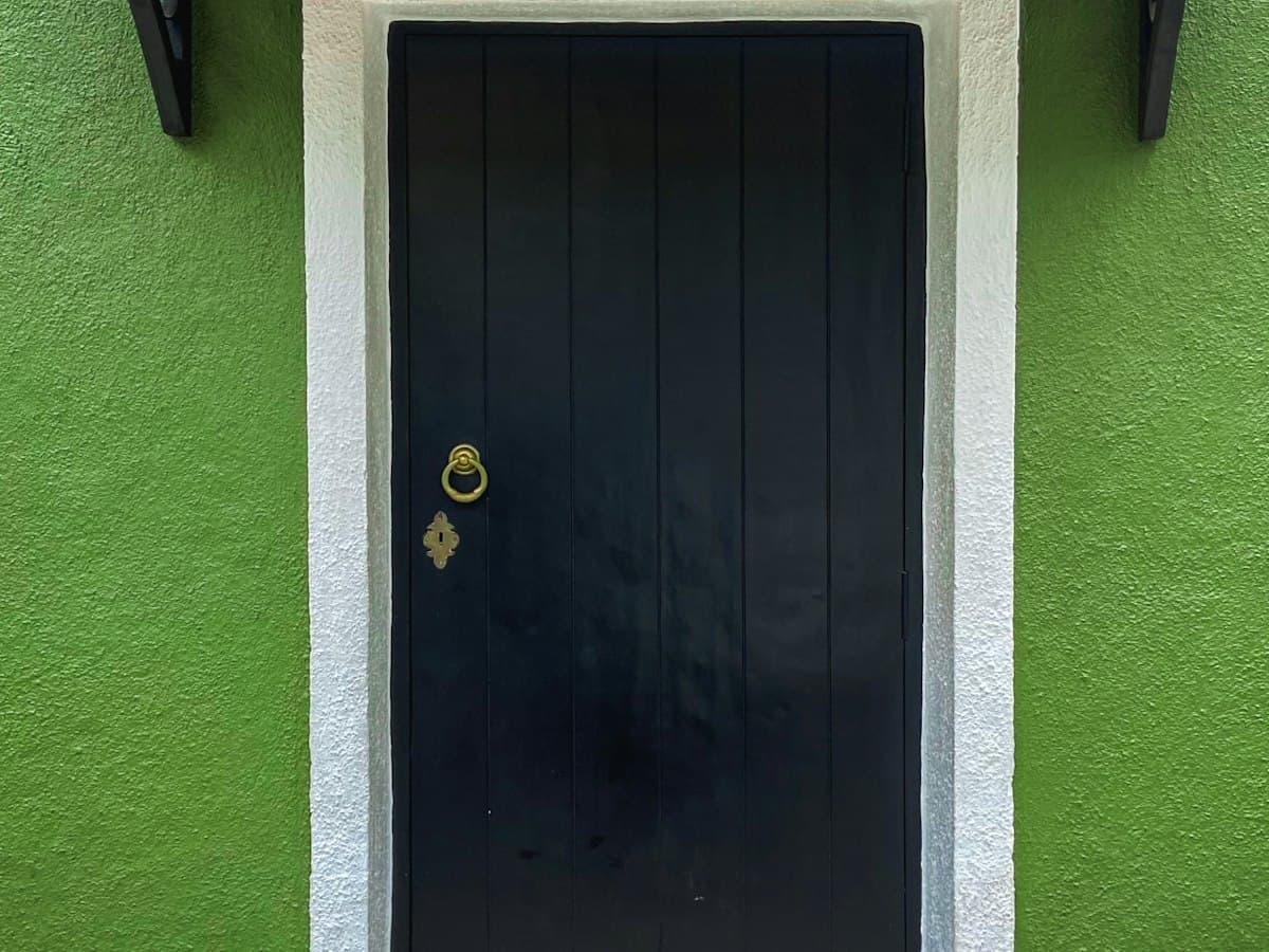 Green Portuguese-era house with black door in the Fontainhas quarter, Panaji