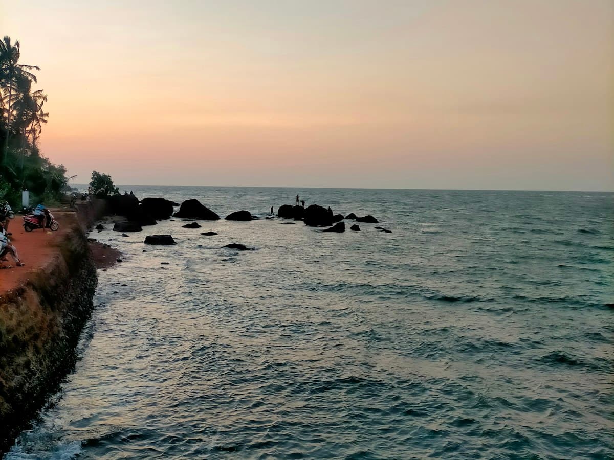 Two people on a bench looking out to sea at Cavelossim, South Goa