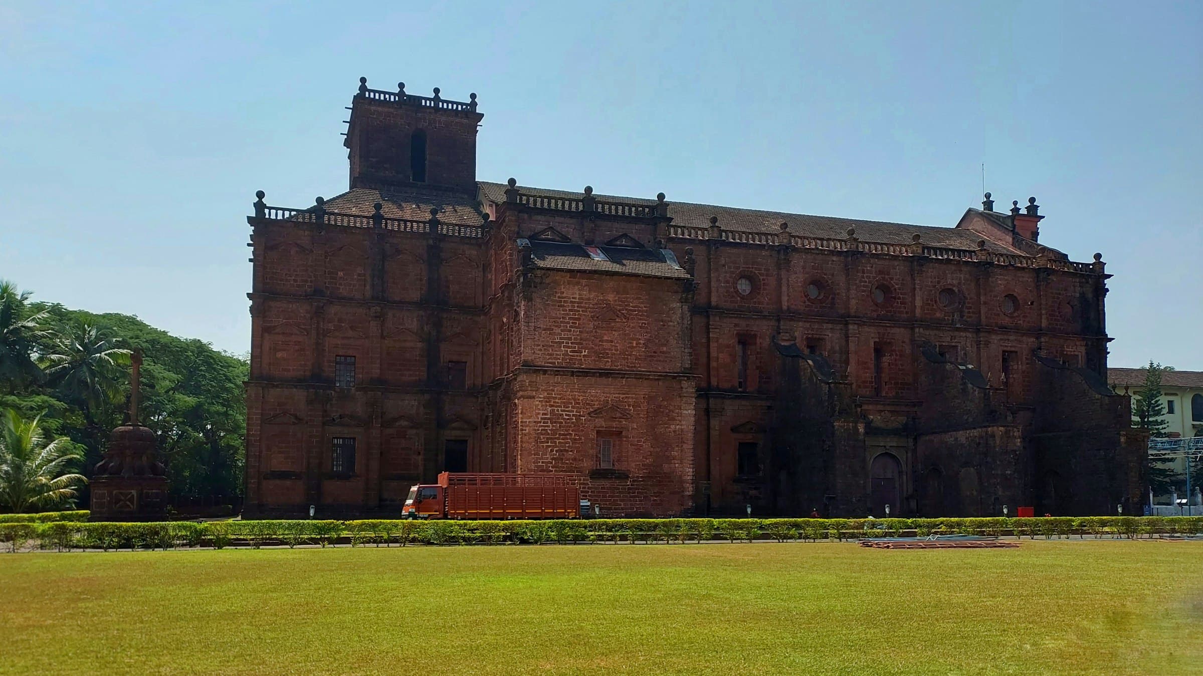 Laterite Portuguese-era church ruins among trees in Old Goa
