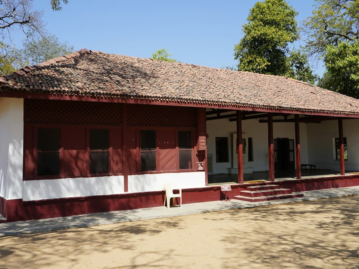 Tiled-roof, red and white ashram building at Sabarmati Ashram, Ahmedabad, in daylight