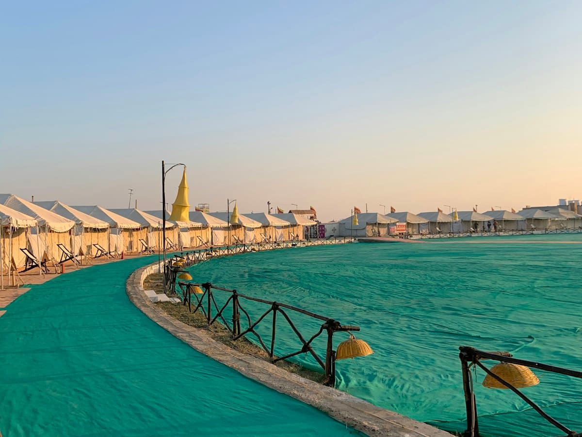 Tent city lined along a curving promenade at golden hour, Rann Utsav, Kachchh, Gujarat