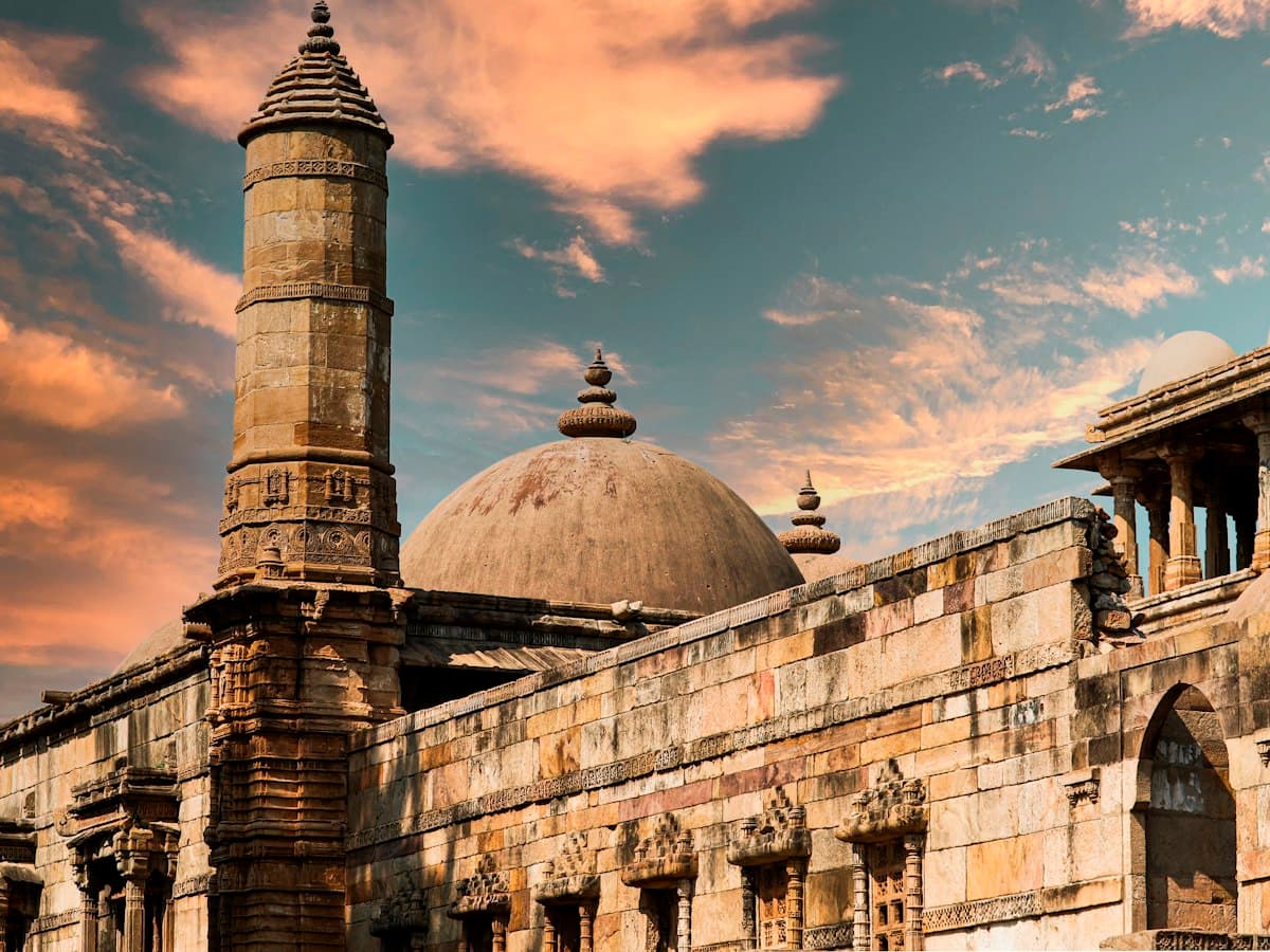 Sandstone minaret and dome of a historic mosque at Pavagadh-Champaner, Gujarat, at sunset