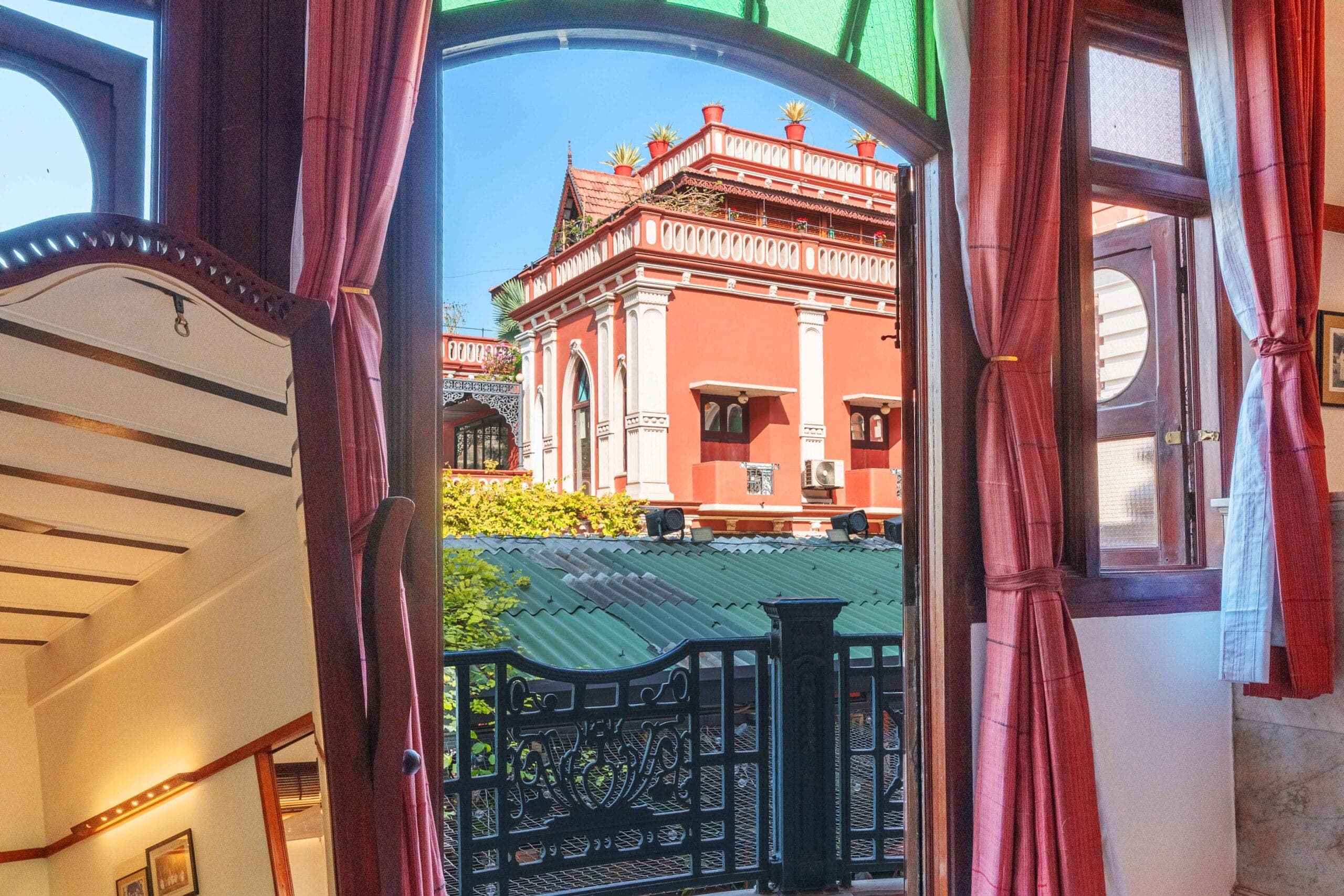 Arched window view across to a heritage building from The House of MG suite, Ahmedabad