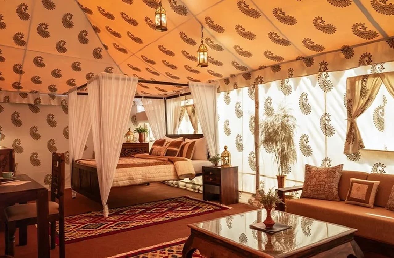 Darbari Suite tent interior with sofa lounge and draped canopy at Rann Utsav Tent City