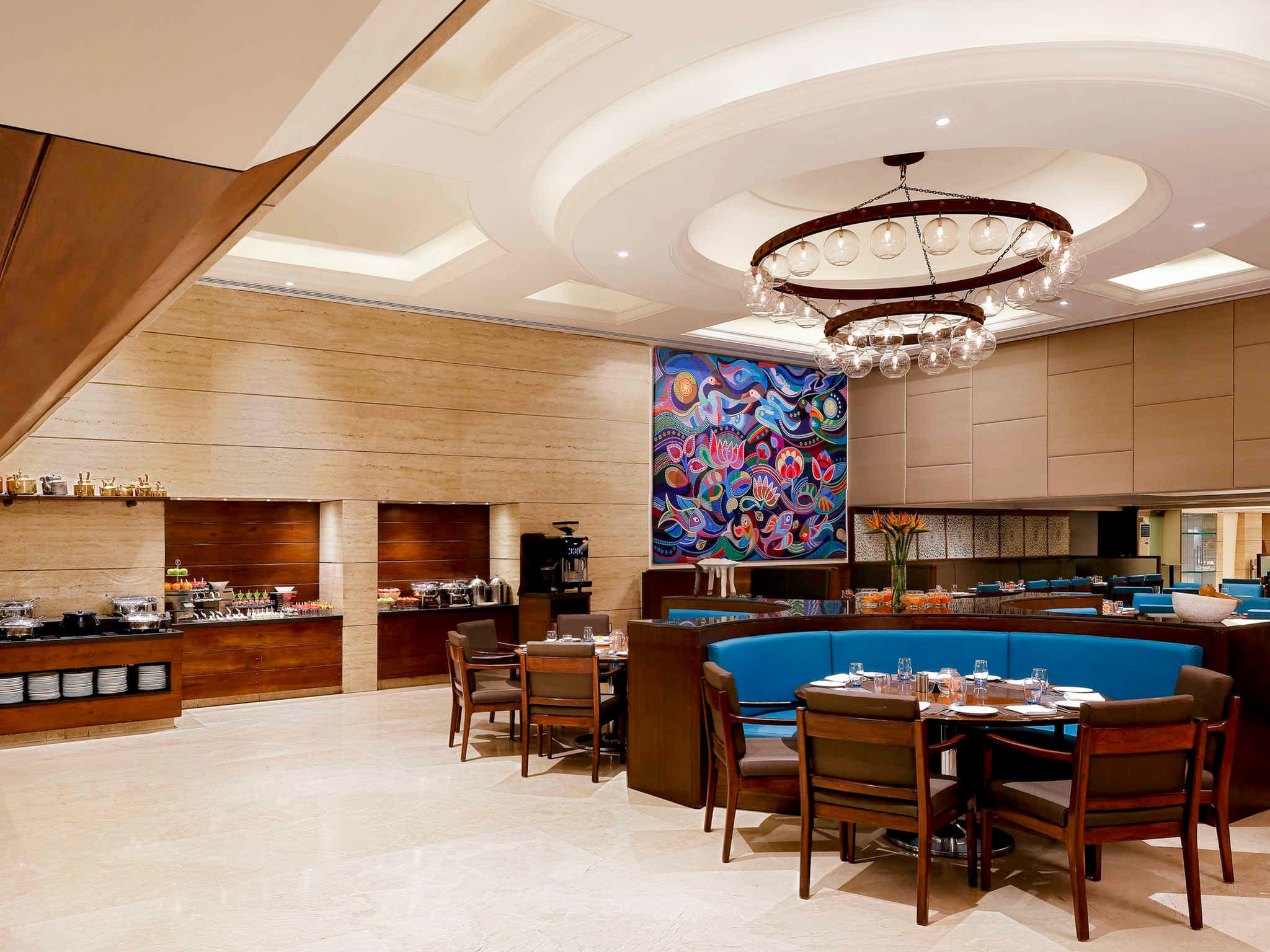 Azure all-day restaurant interior with chandelier and open kitchen at Grand Mercure Vadodara