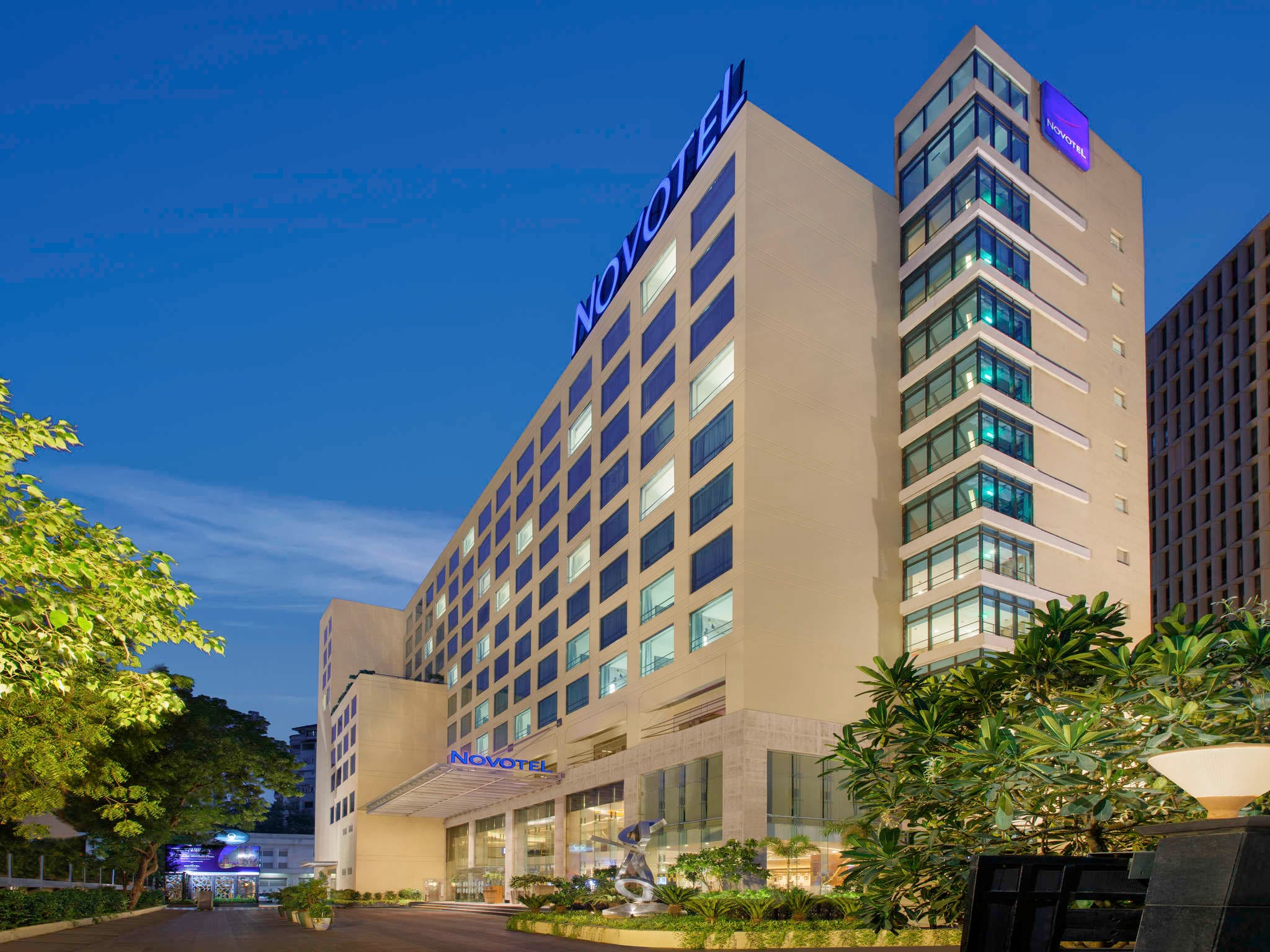 Twilight exterior of Novotel Ahmedabad tower on S G Highway