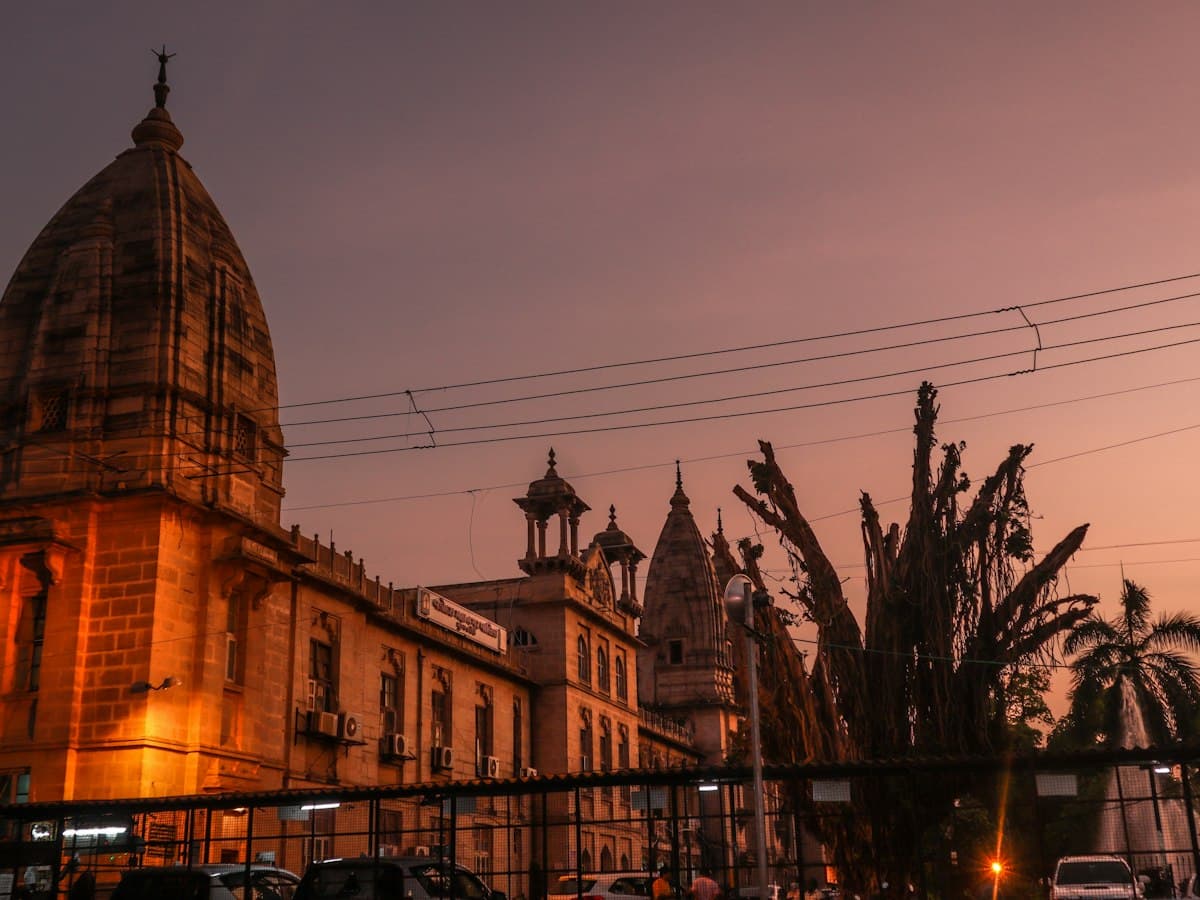 Historic sandstone building with a domed tower glowing in the evening light in Vadodara, Gujarat