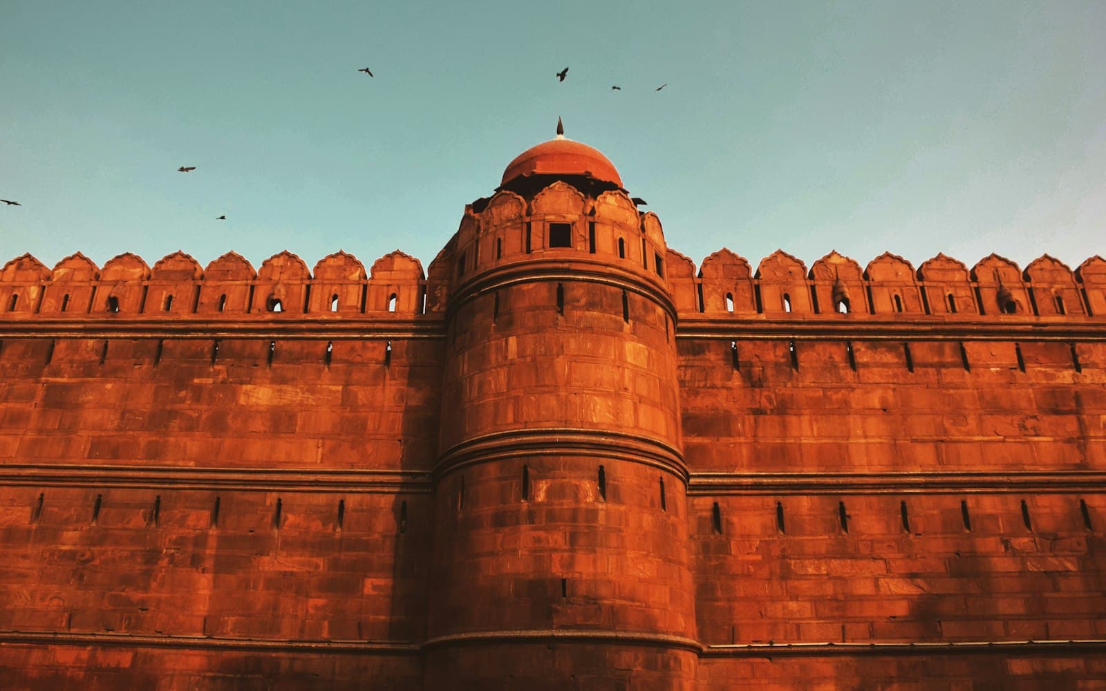 A red sandstone rampart wall and round bastion of the Red Fort, Delhi