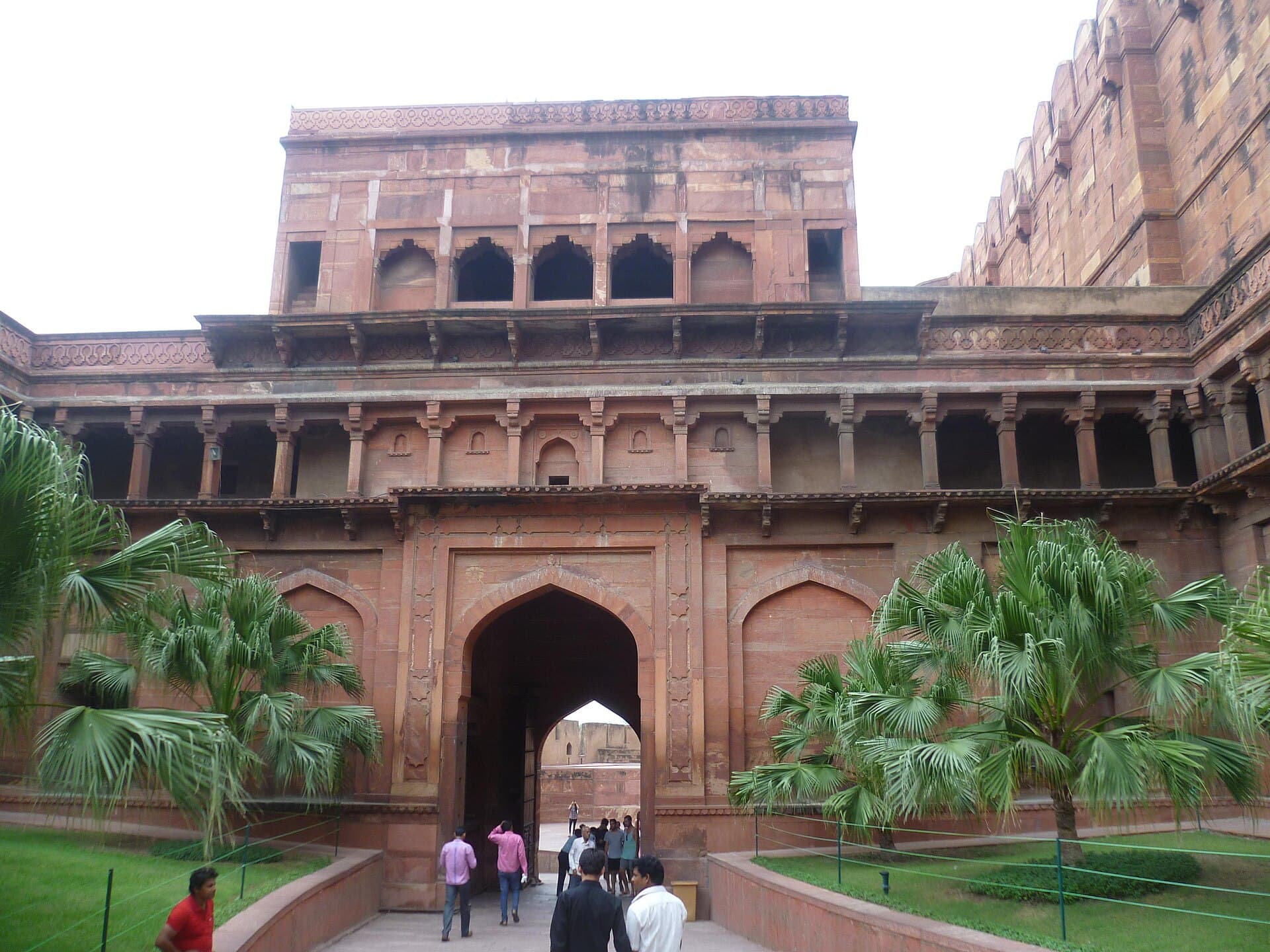 Visitors walking through the red sandstone Amar Singh Gate at Agra Fort