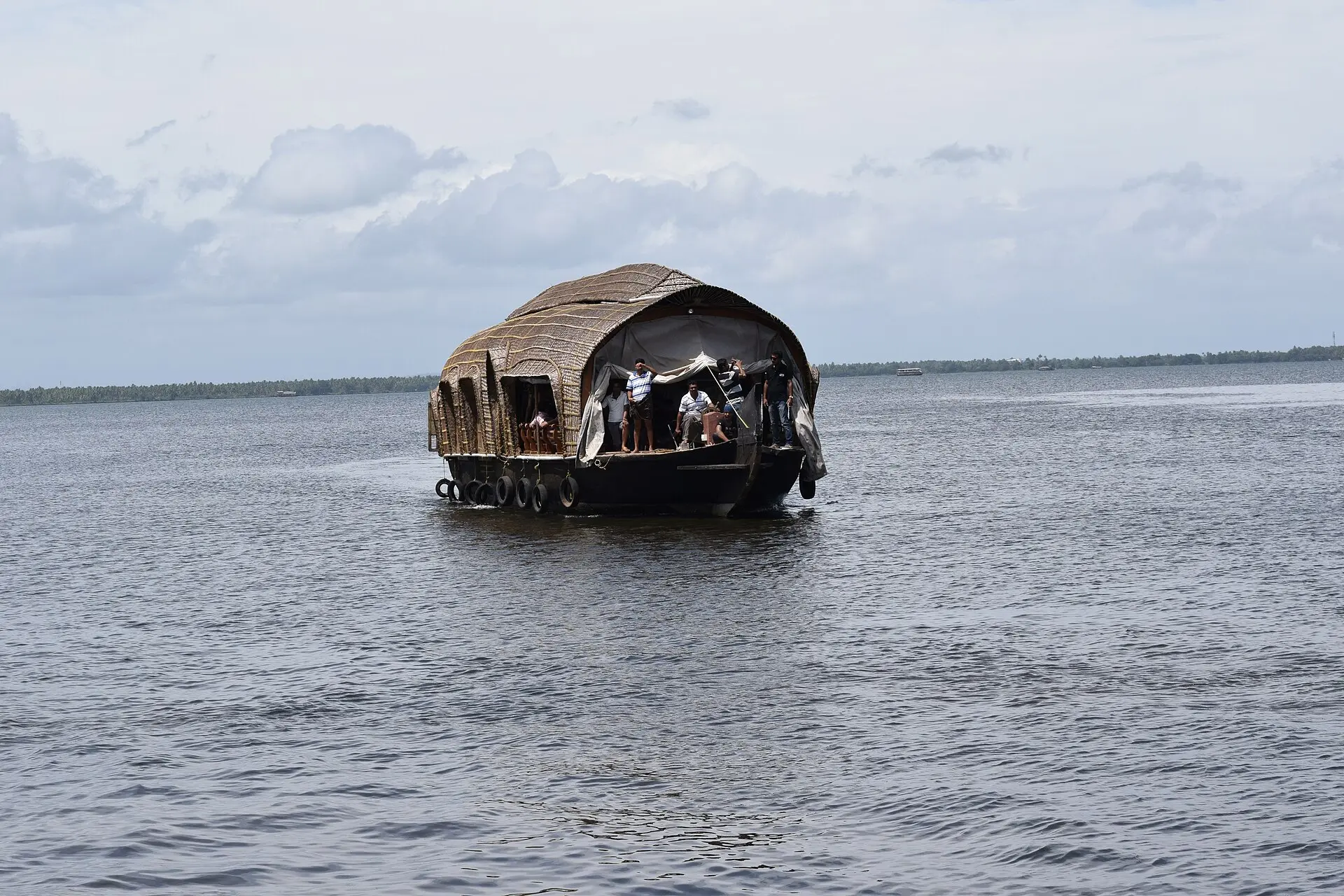 A kettuvallam houseboat on the open water of Vembanad Lake