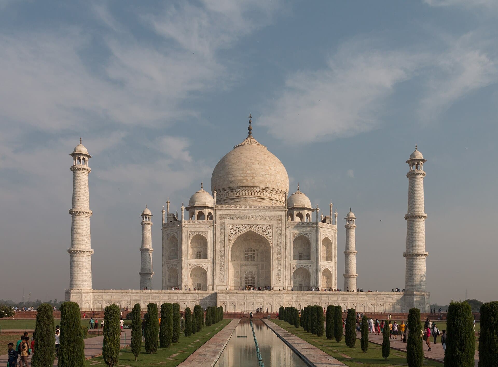 The Taj Mahal and its garden seen from an angle across the lawns in soft light
