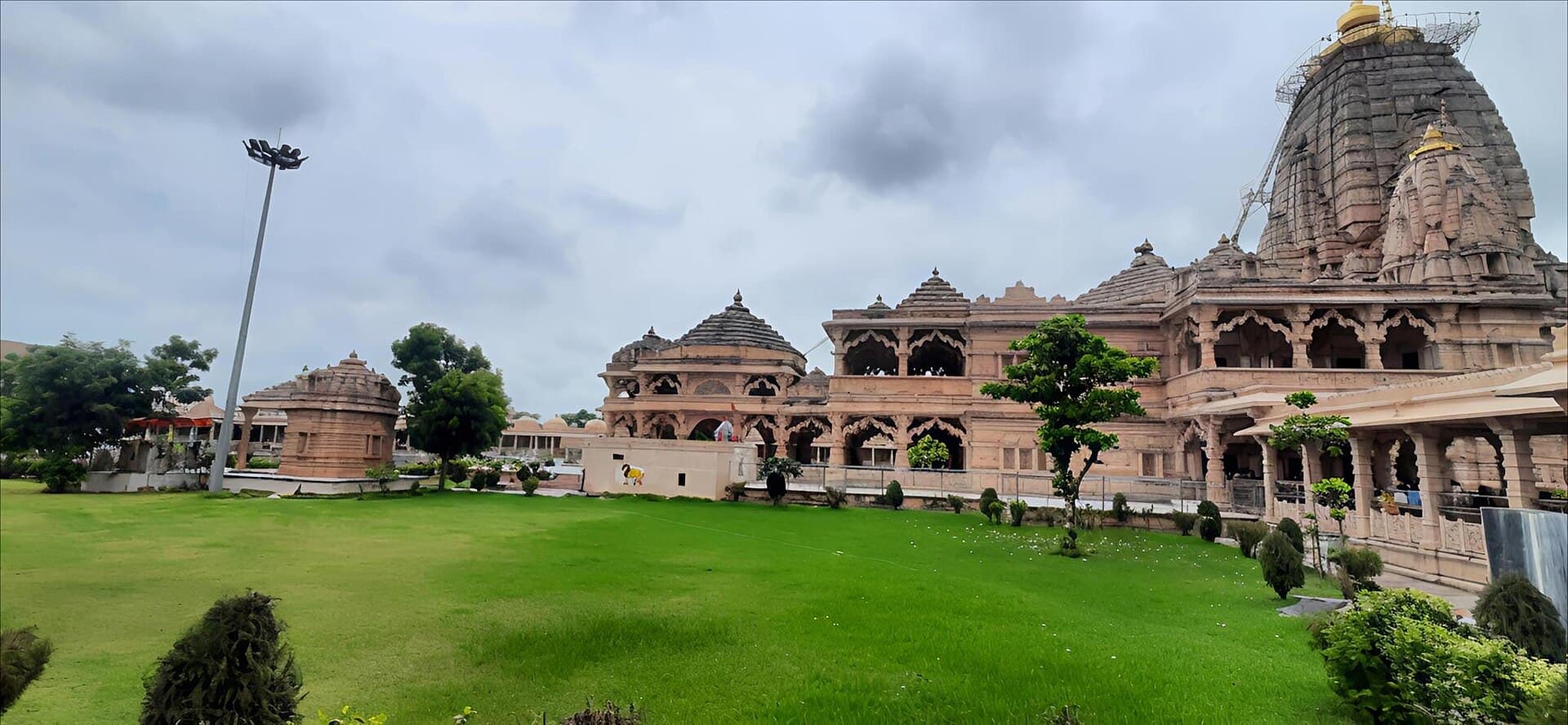 Pink stone Sawariya Seth temple at Mandphiya, Rajasthan, with a lawn in front