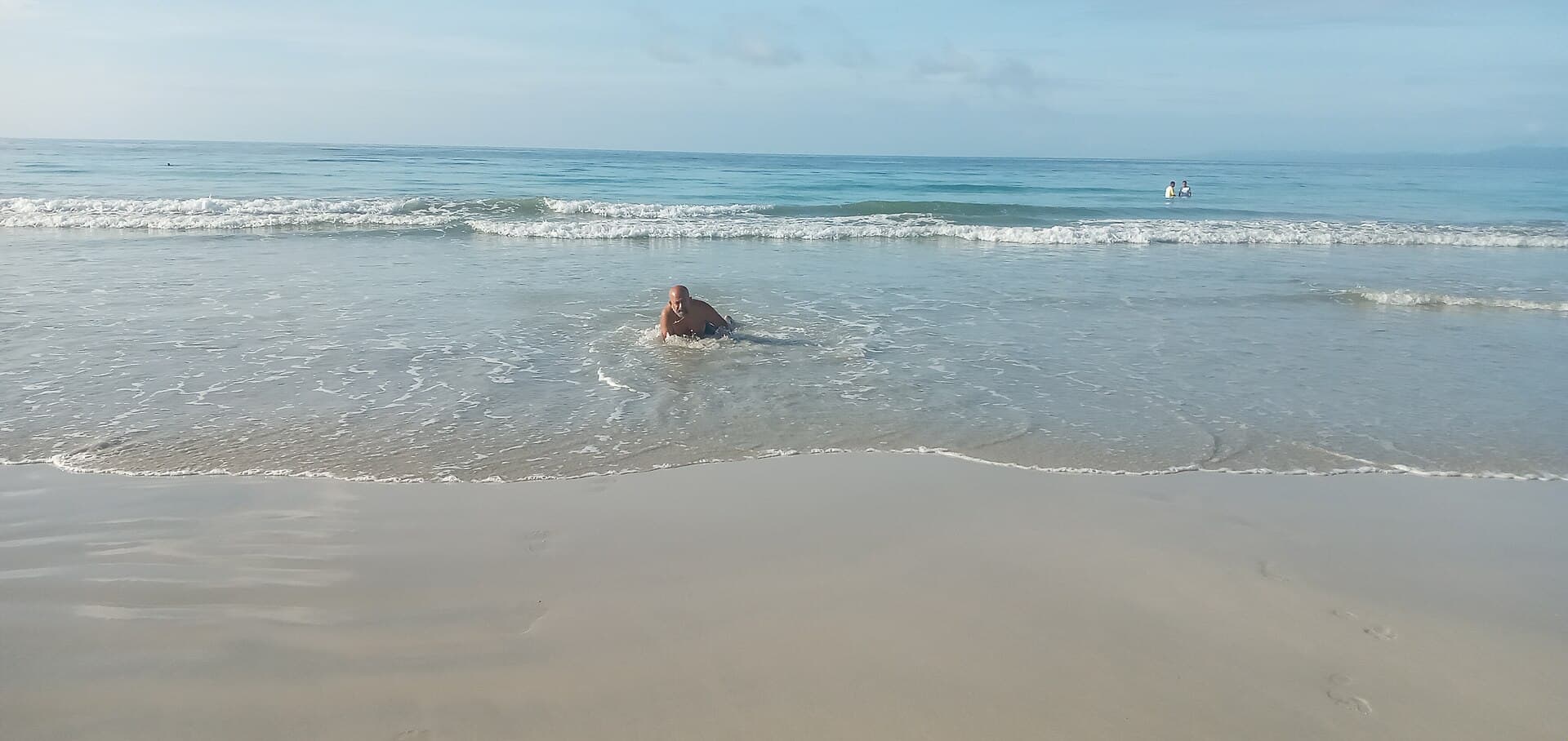 Gentle surf on the pale sand of Radhanagar Beach, Havelock Island, in the morning