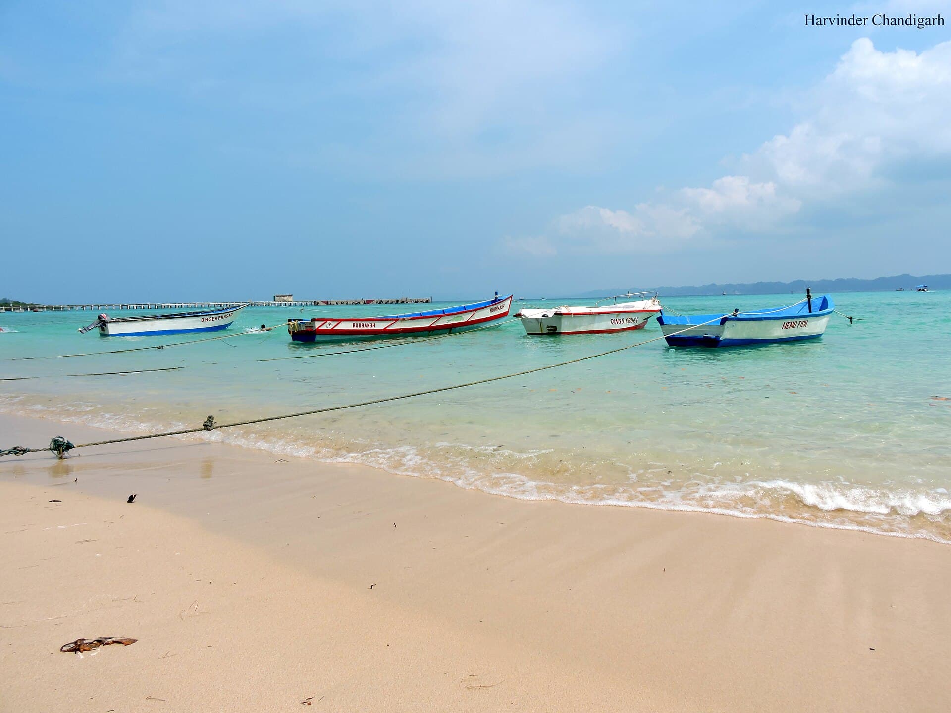 Boats moored on the sand at Bharatpur Beach, Neil Island, with clear shallow water