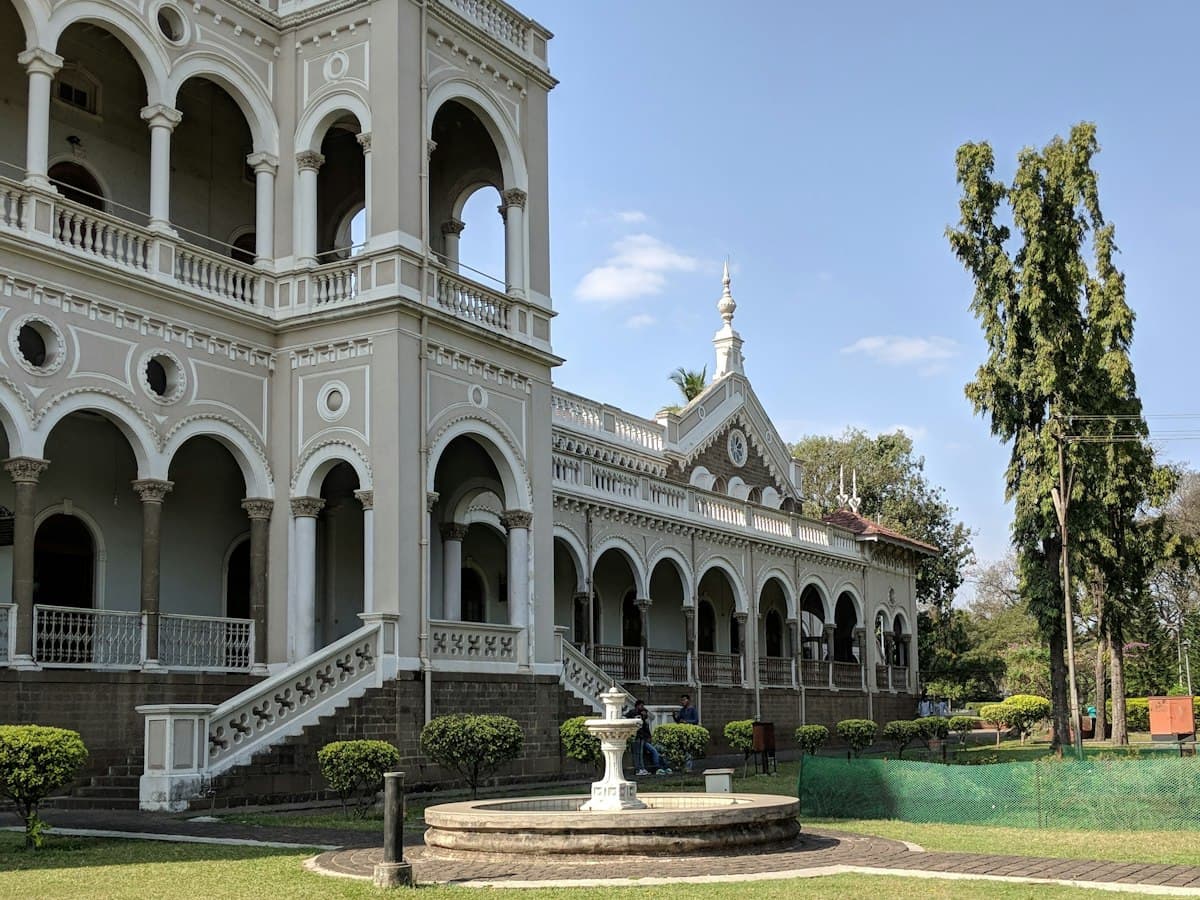 The white Aga Khan Palace with a water fountain in front, Pune, Maharashtra