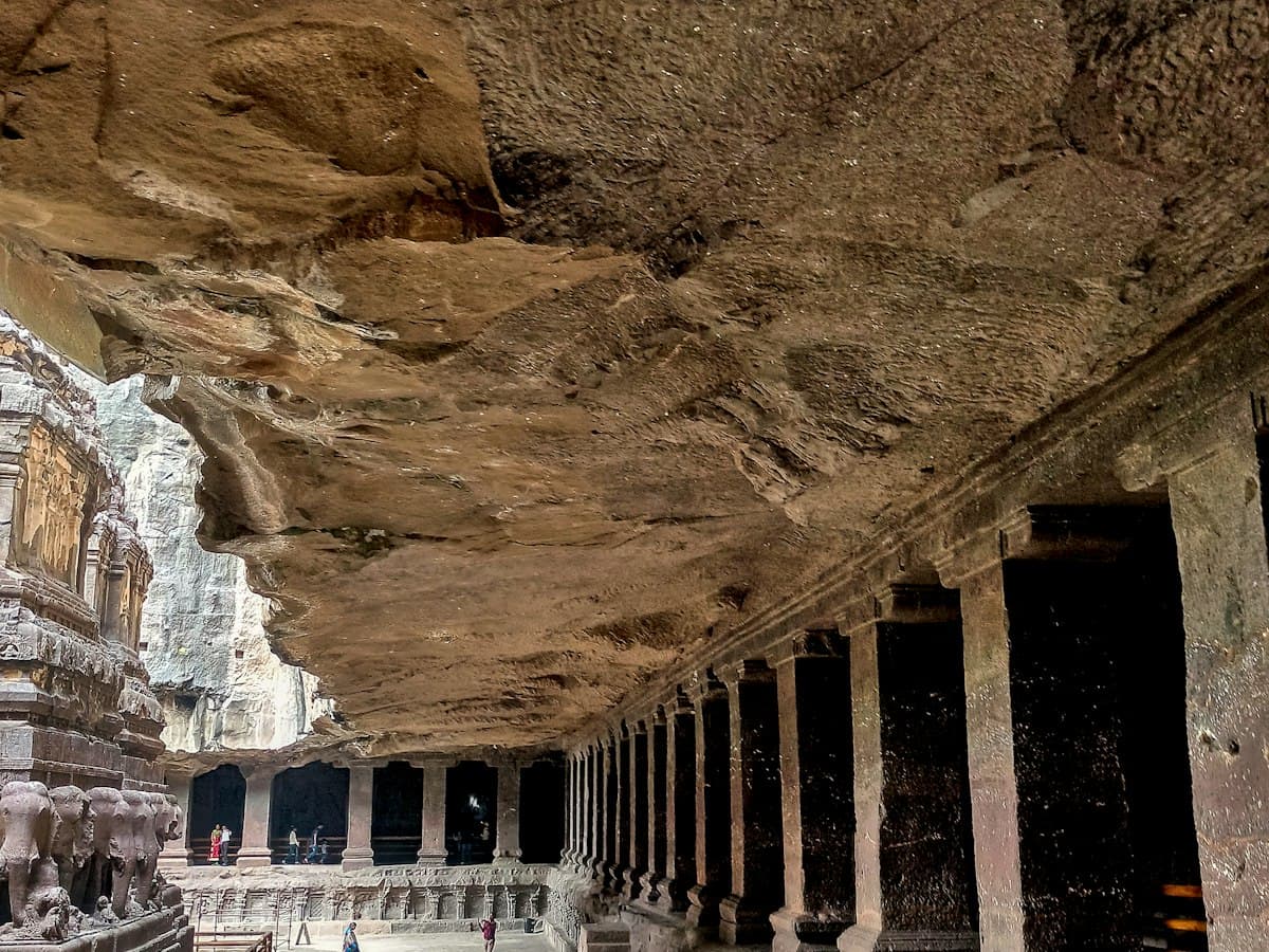 A sculpted stone walkway between rock-cut structures at the Ellora Caves, Aurangabad