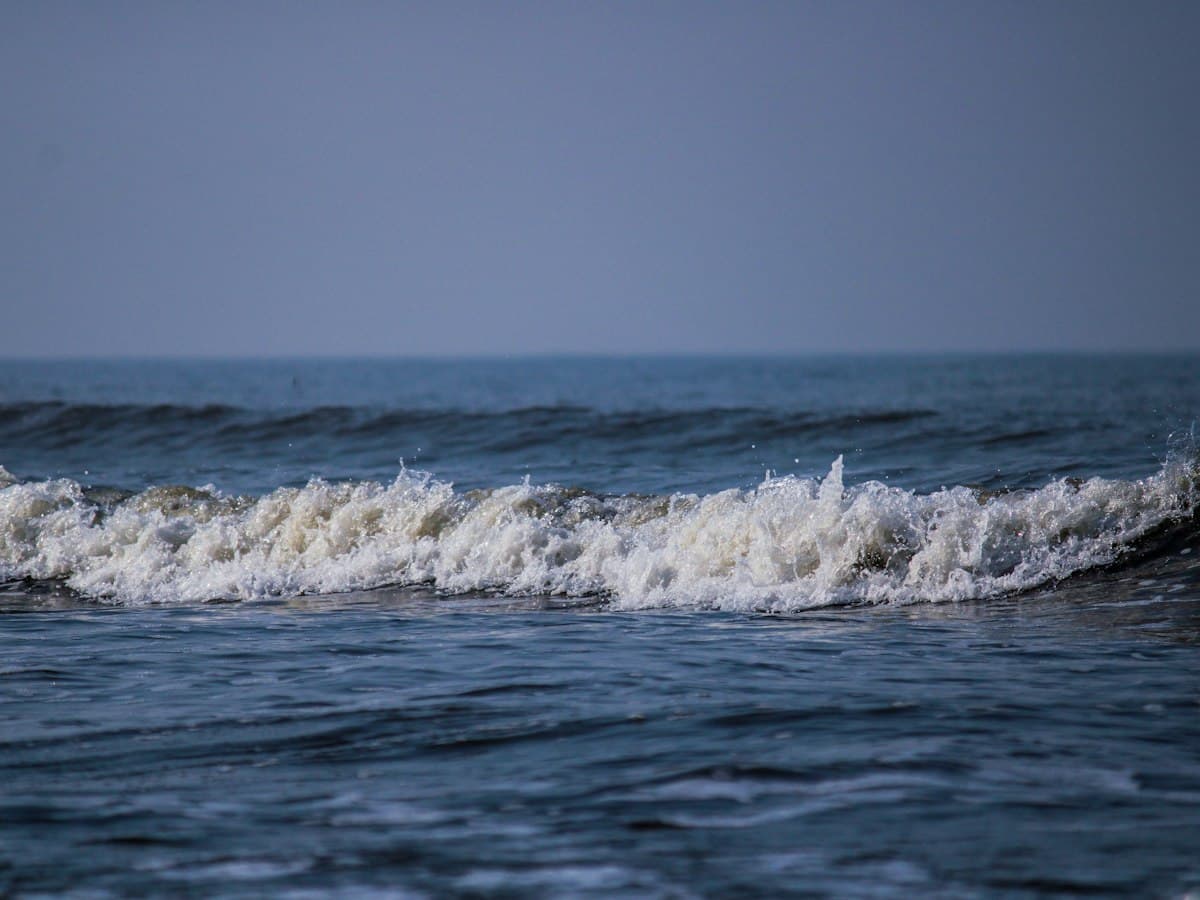 Waves breaking on the shore at Alibag, Maharashtra