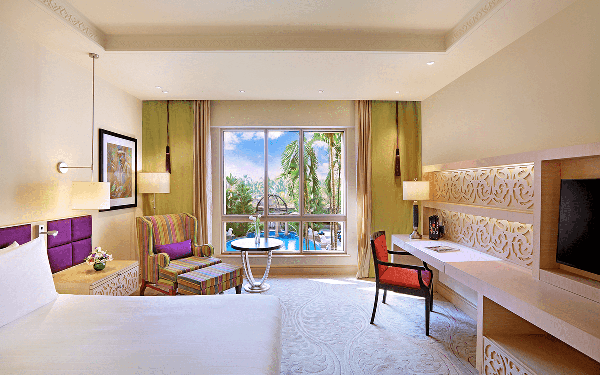 Executive Club room with king bed, work desk and garden-facing window at ITC Maratha, Mumbai