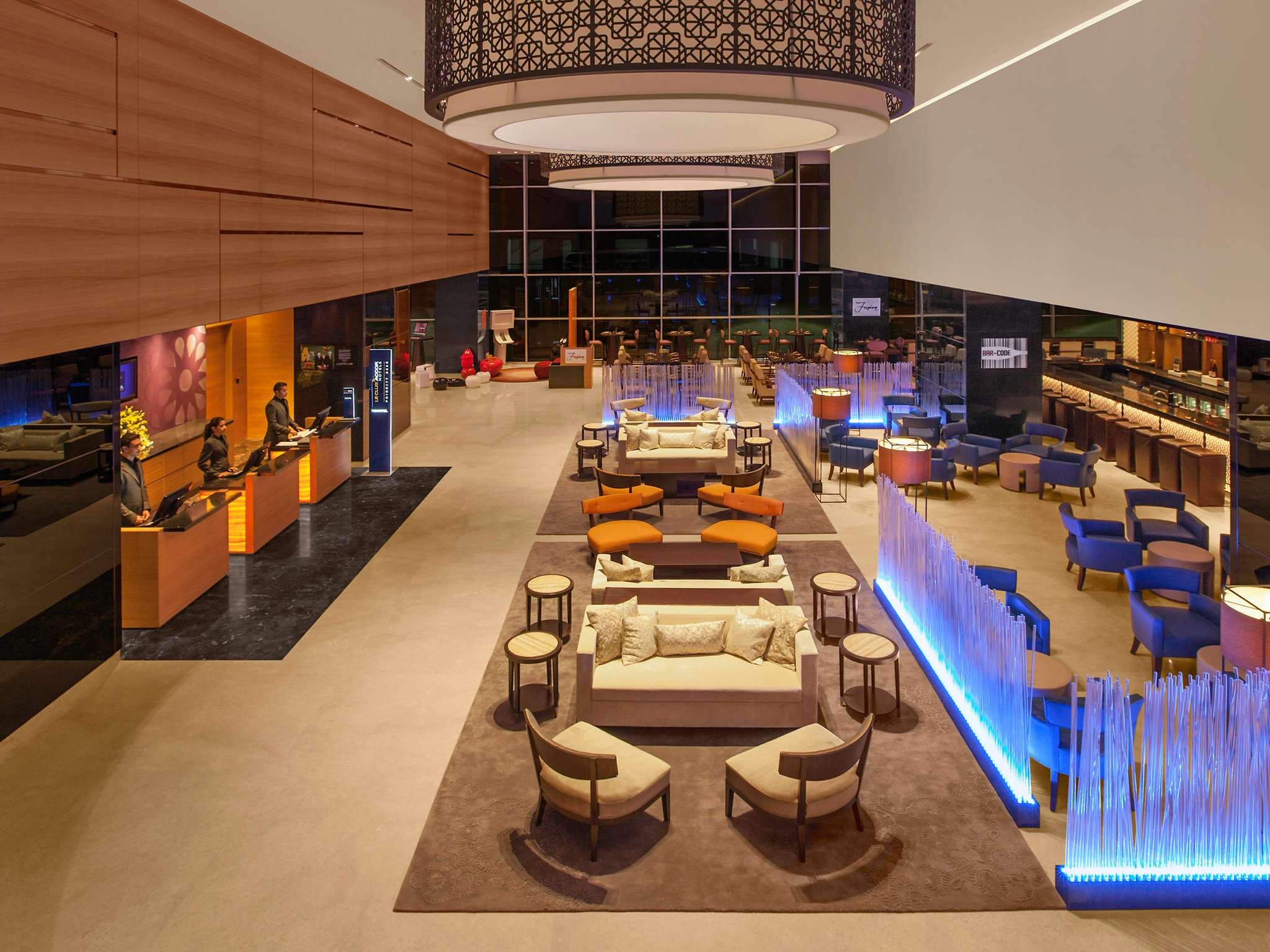 Open lobby with reception, sofas and the lounge bar at Novotel Pune Nagar Road