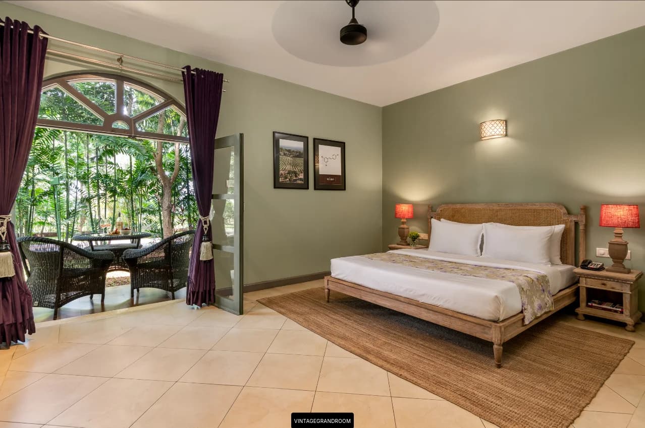 Vintage Grande Room with a king bed, sage walls and an arched window to the terrace at The Source at Sula