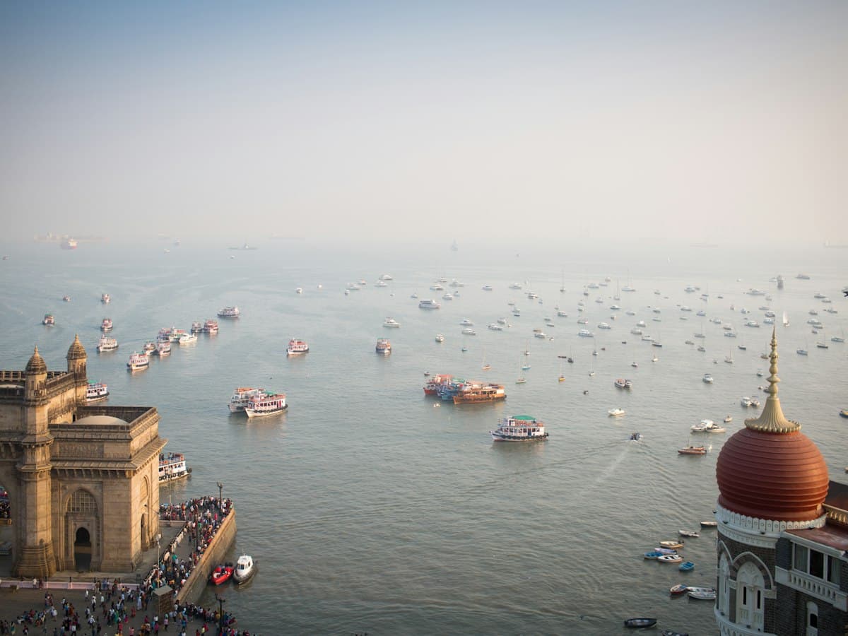 Boats on the water of Mumbai harbour beside the Gateway of India waterfront, seen from a hotel room